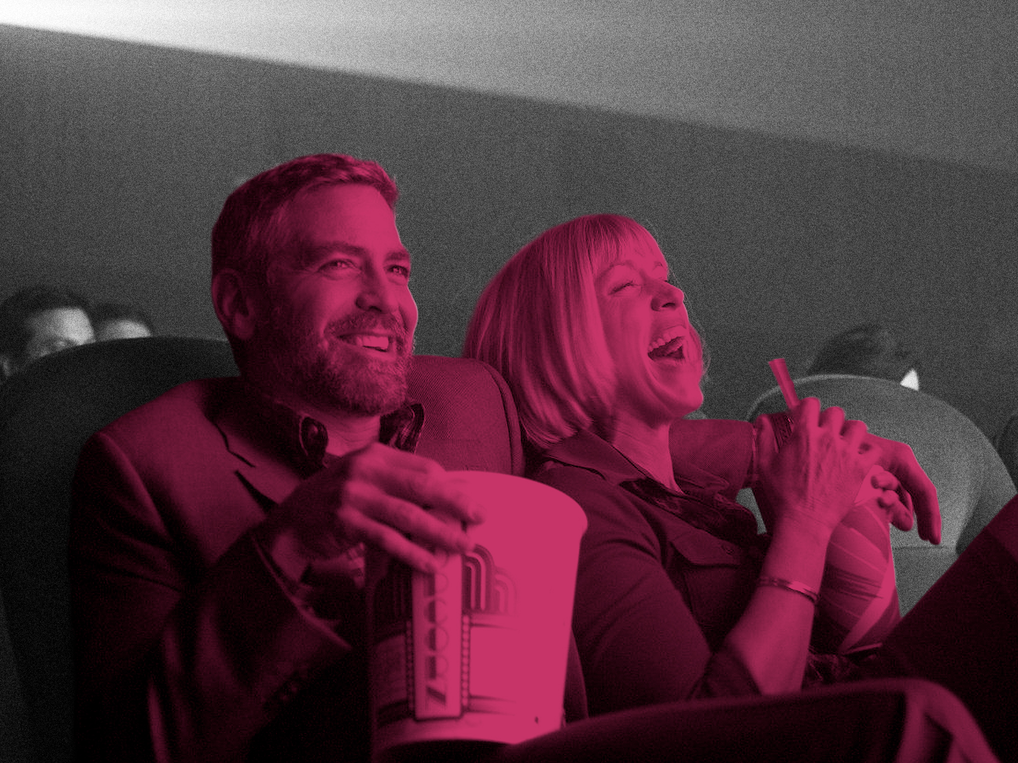 Two people laughing whilst holding popcorn in cinema seats, image tinted pink and magenta with grey background.