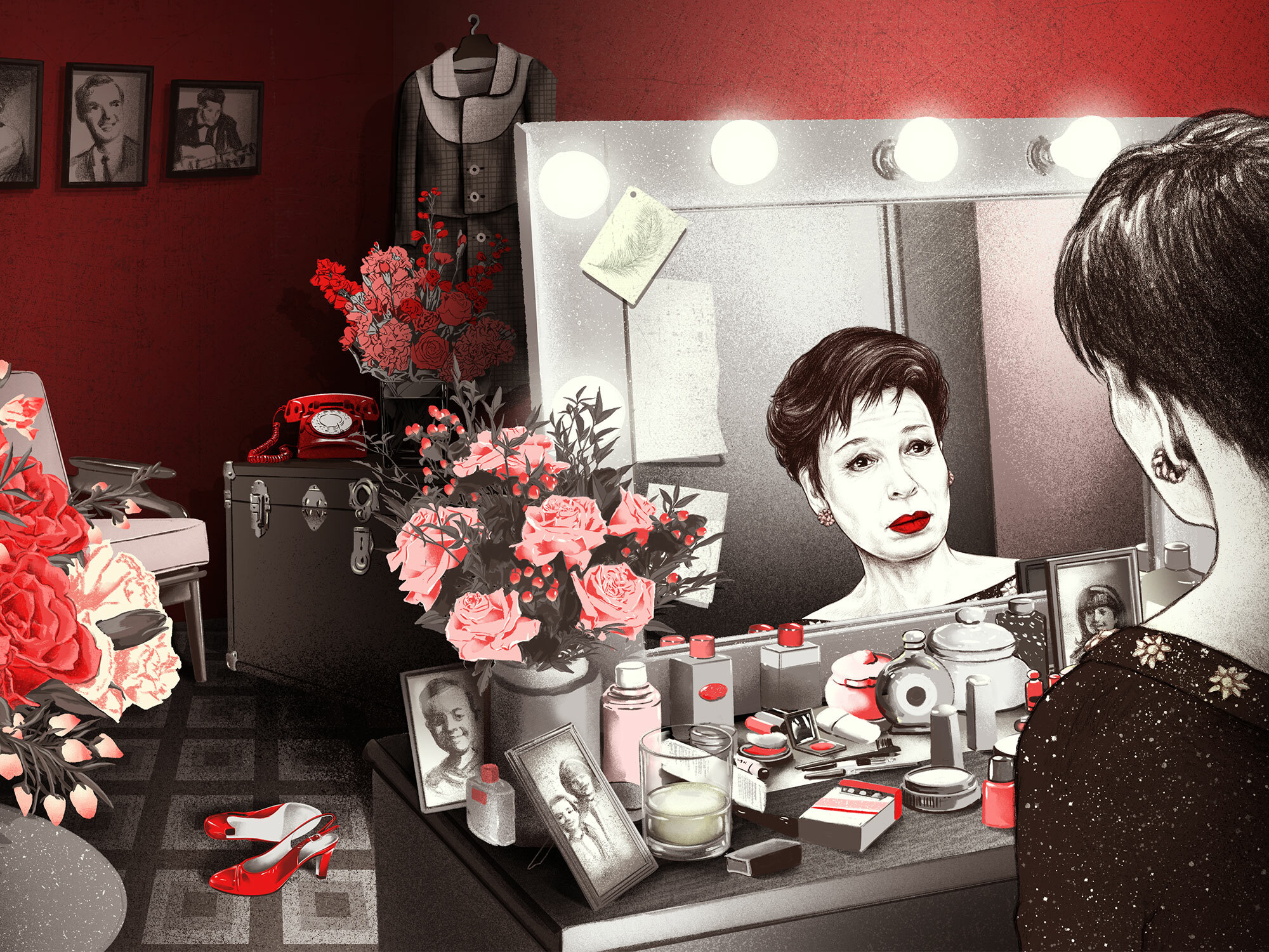 Cluttered dressing table with makeup, flowers, and framed photographs.