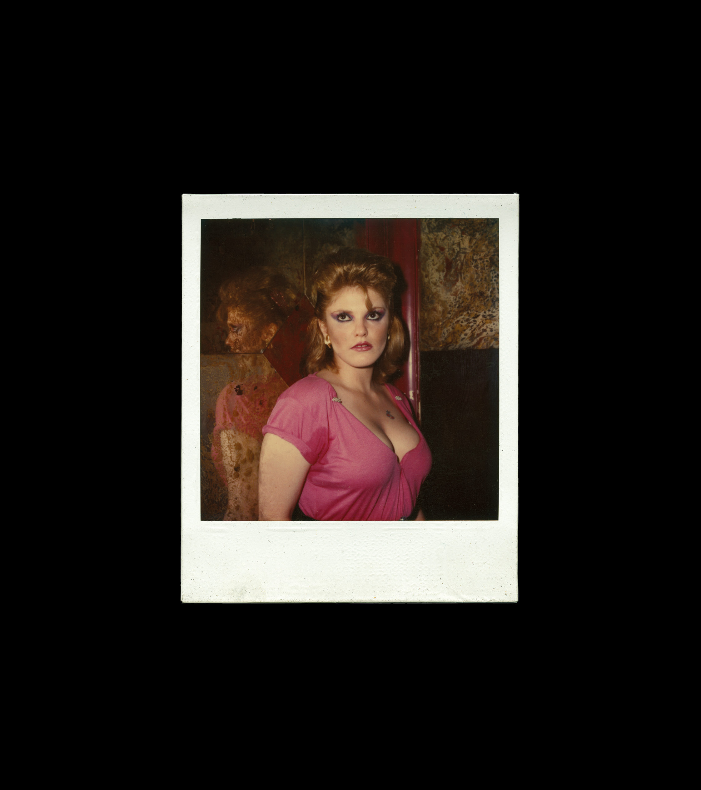 Woman in pink top, dark background