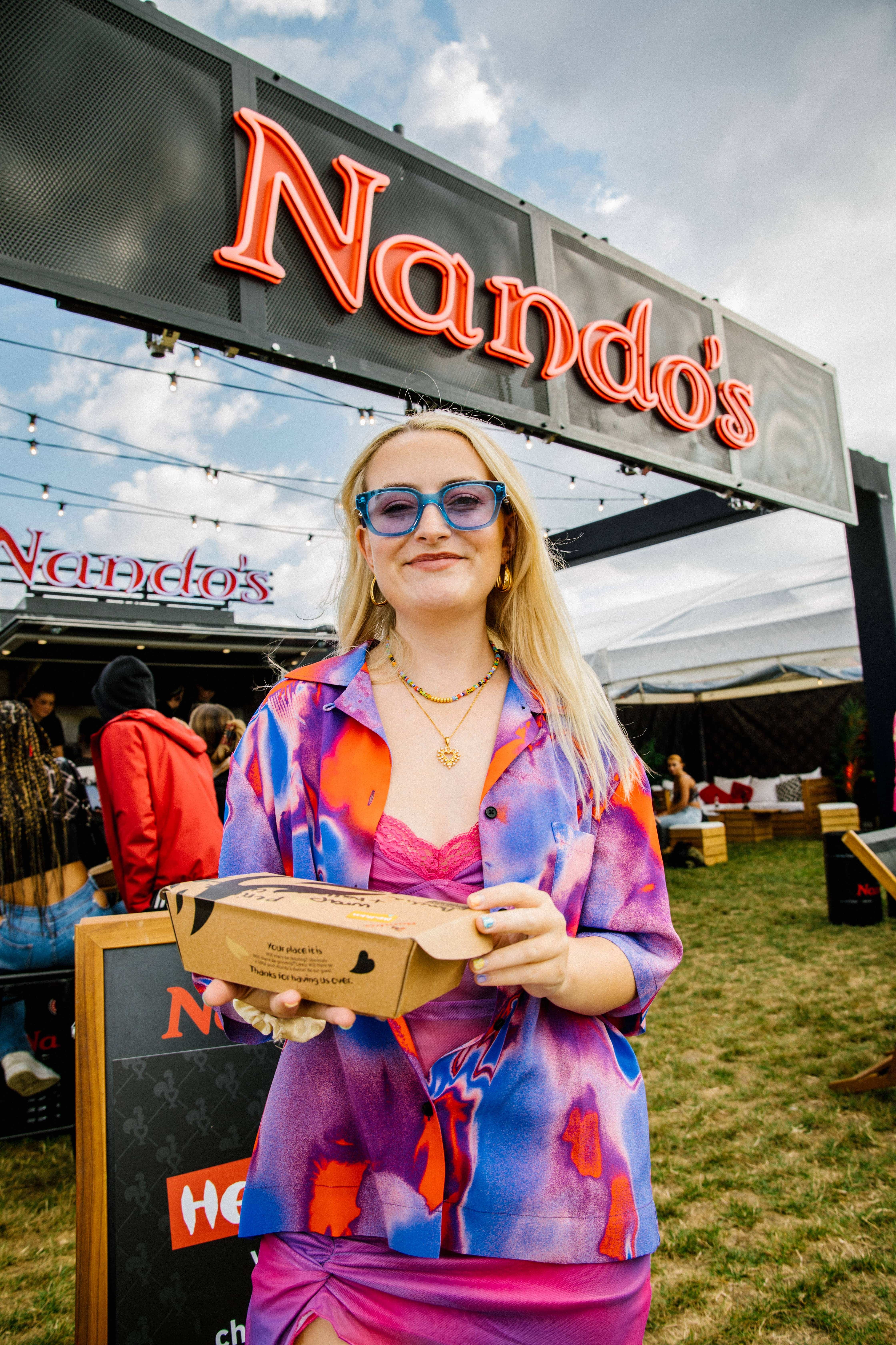 Chicken Shop Dates Amelia Dimoldenberg caught feasting on some delicious PE Ri PE Ri backstage on Day One of Strawberries and Creem Festival