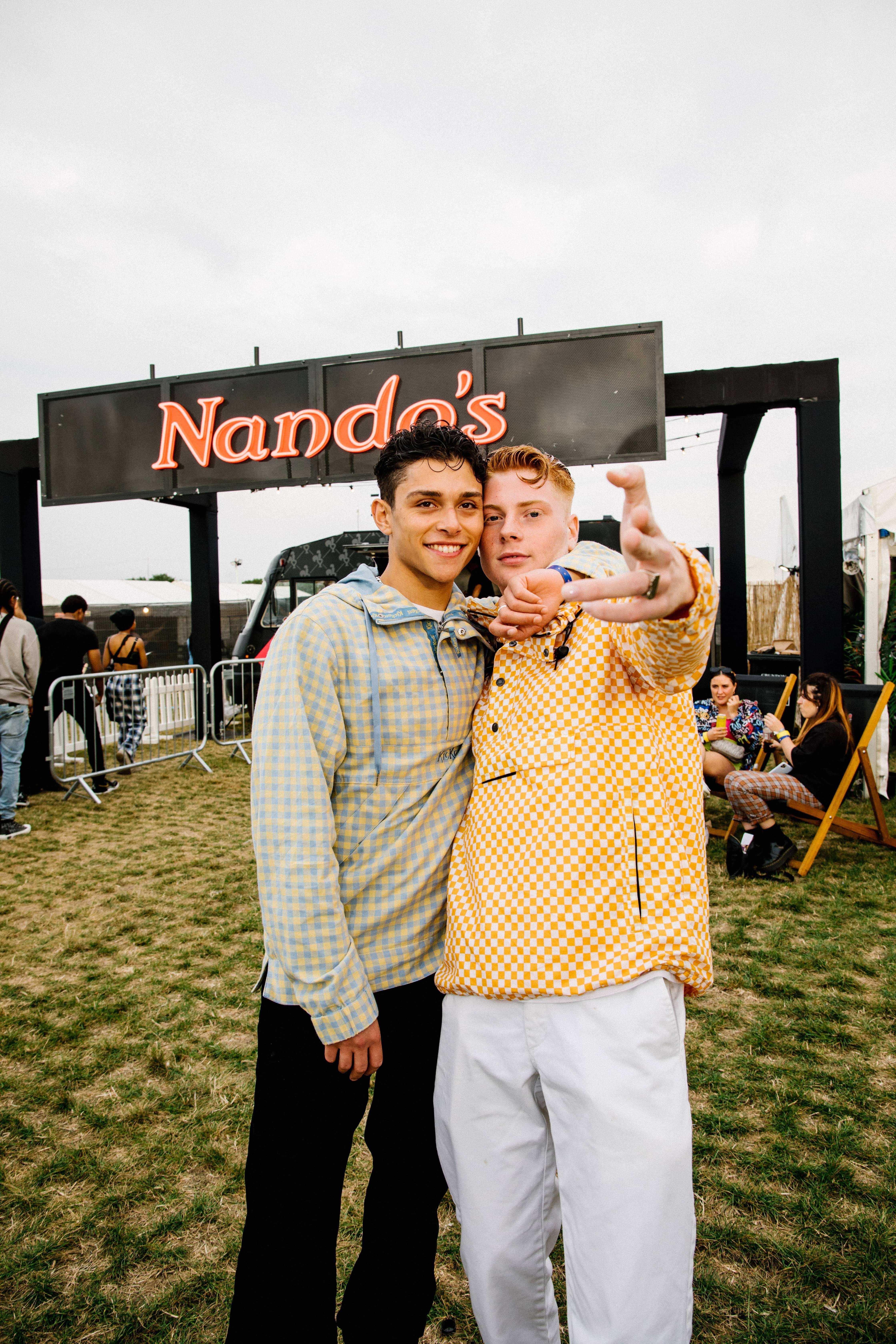 Streetwear icon Leo Mandella AKA Gully Guy Leo poses with his boyfriend whilst waiting to fuel up on Nandos at Strawberries and Creem Festival Day Two
