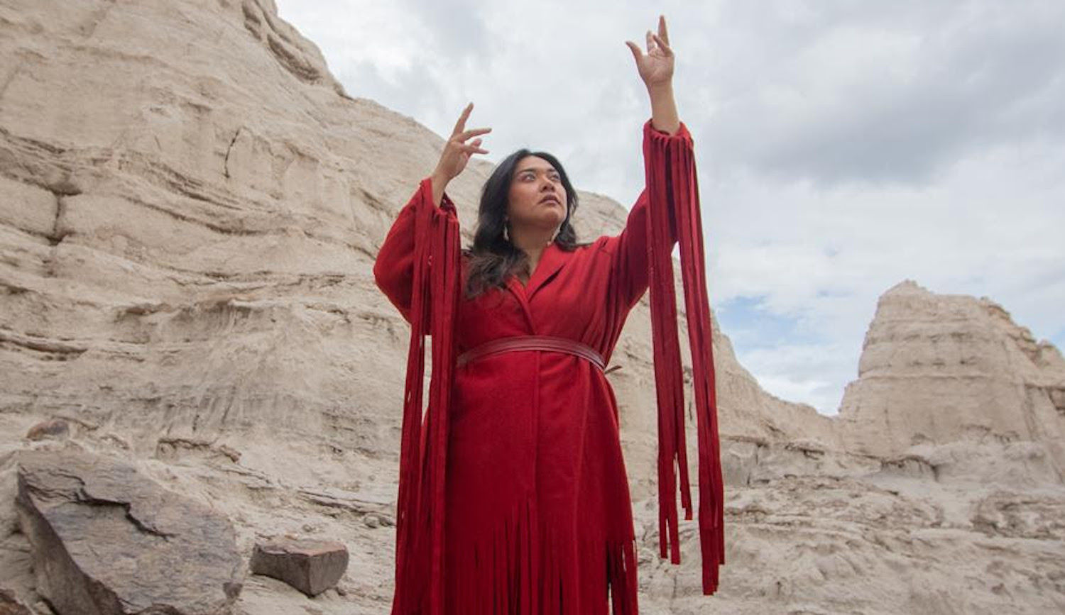 Black Belt Eagle Scout red dress stood in front of rocks