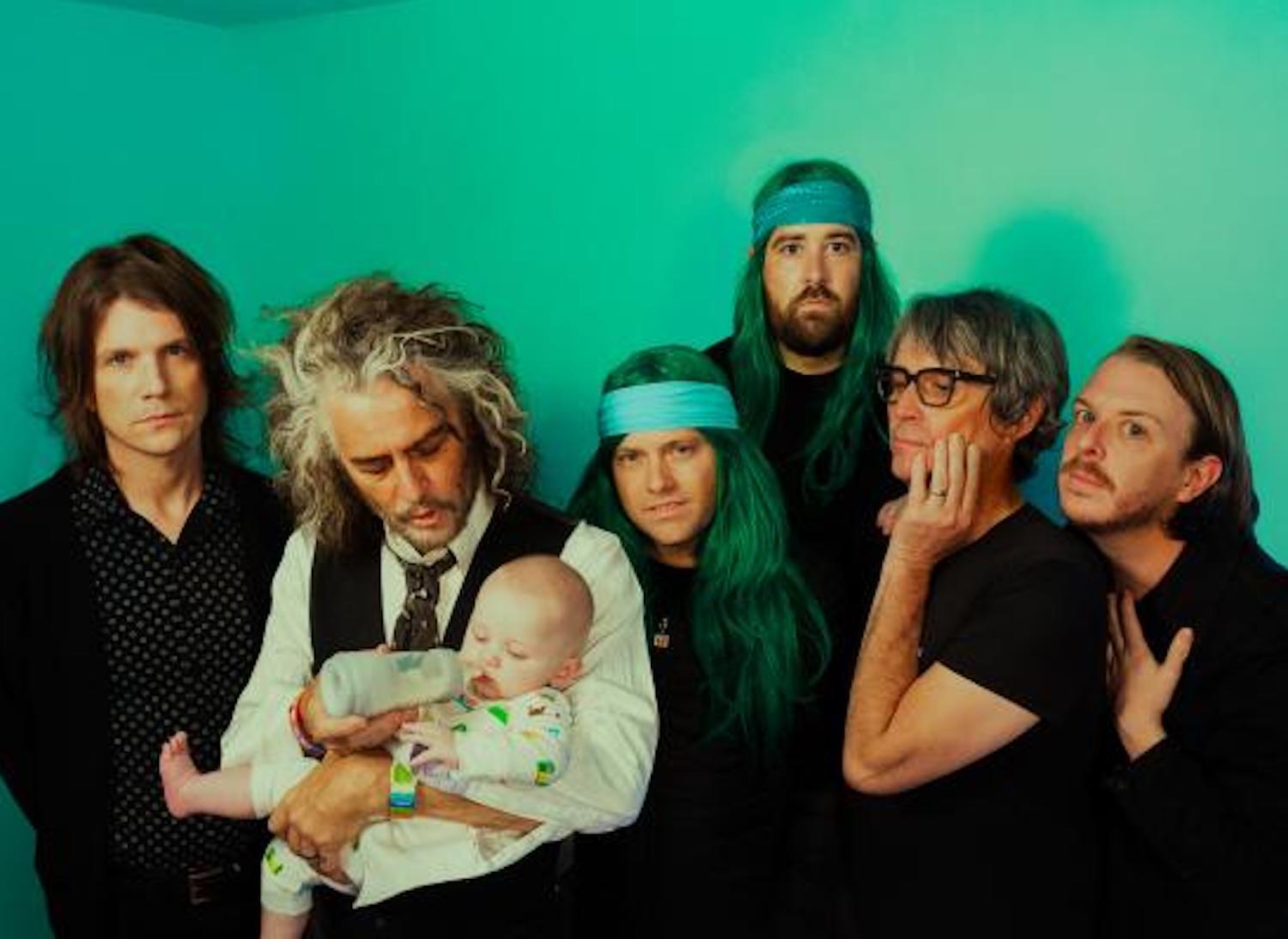 Flaming Lips green wall Wayne holding baby