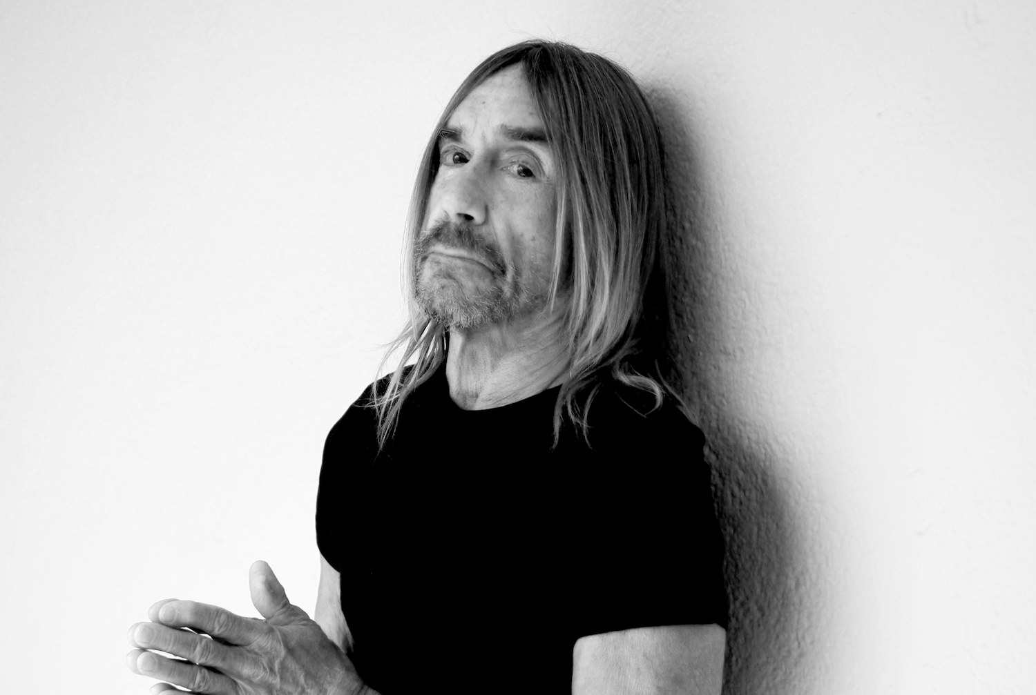 Iggy Pop monochrome portrait against white wall