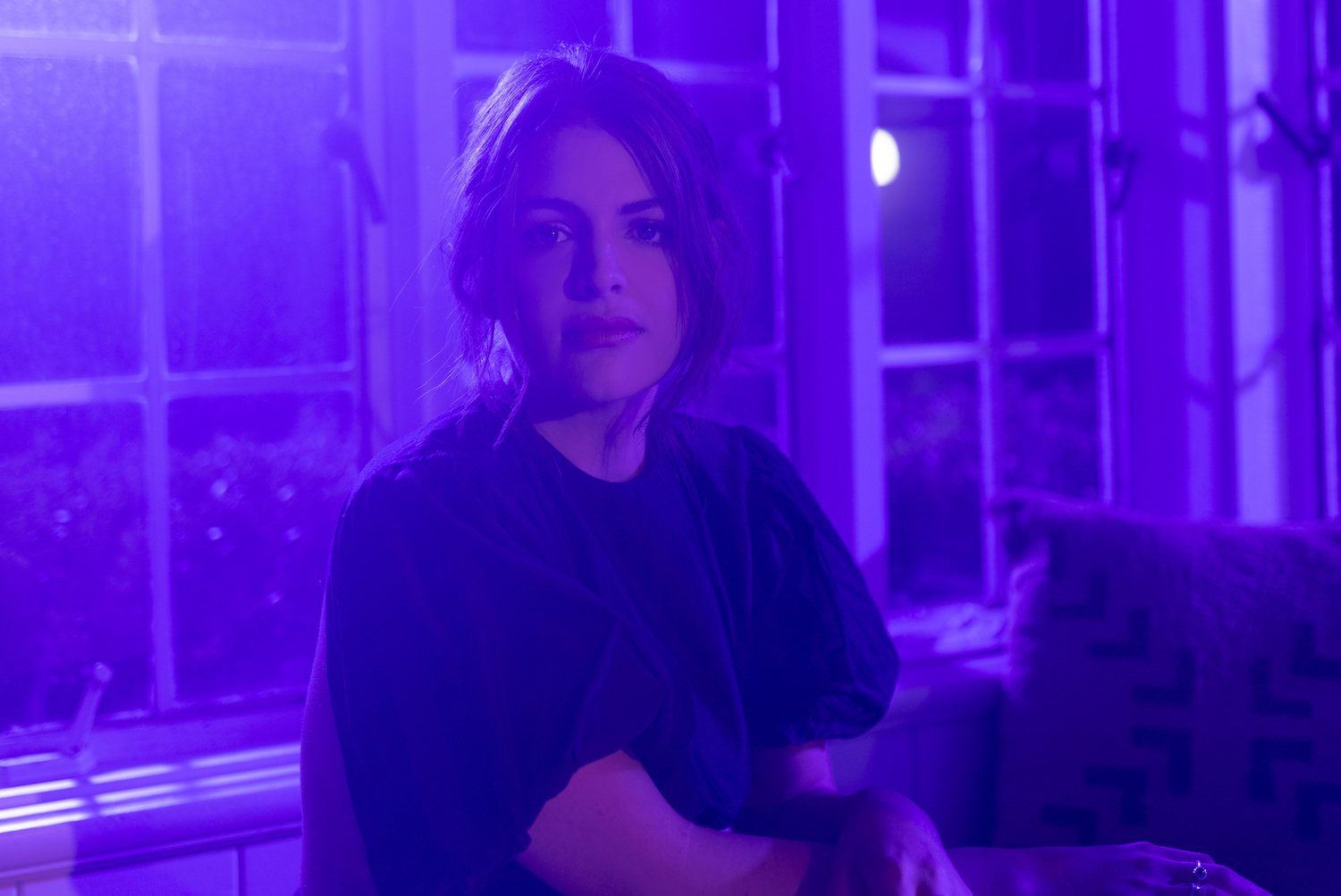 Indy Yelich sat at a table in a purple room