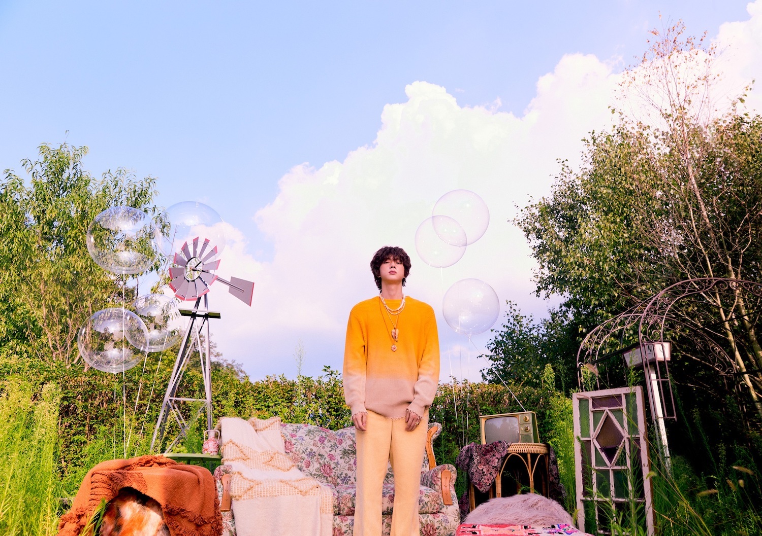 Jin orange jumper garden shot for The Astronaut