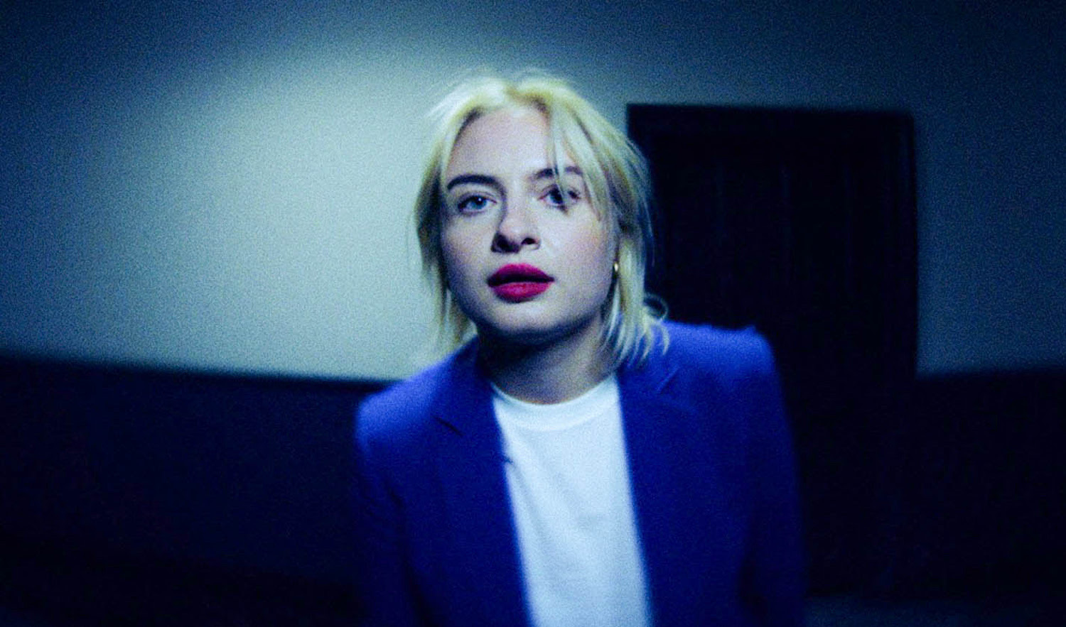 Lapsley wearing blue suit and white t-shirt