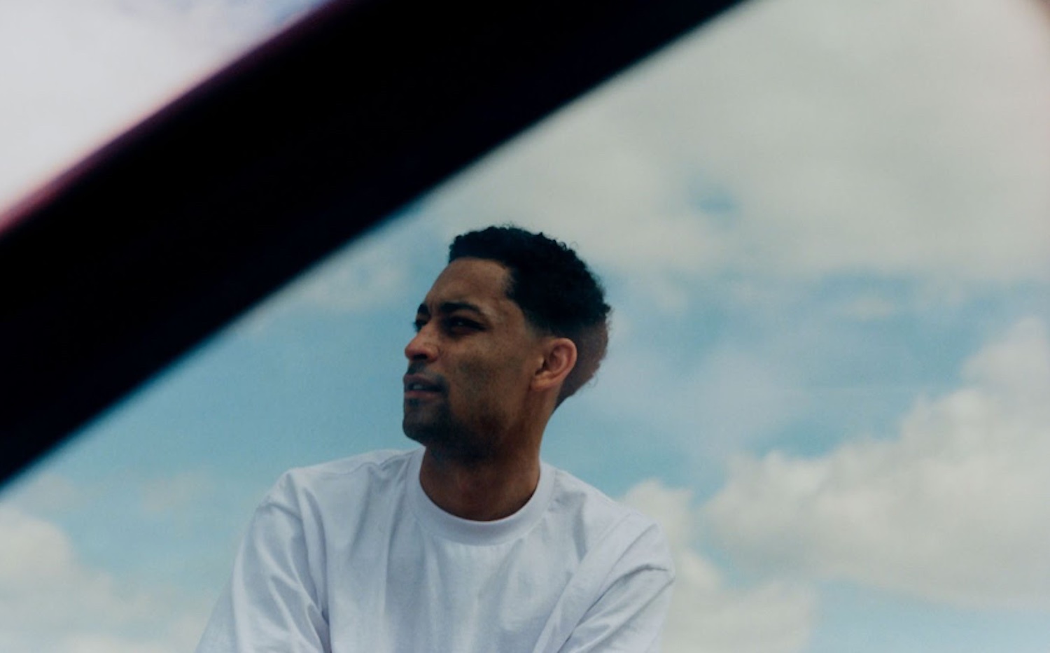 Loyle Carner through a car window