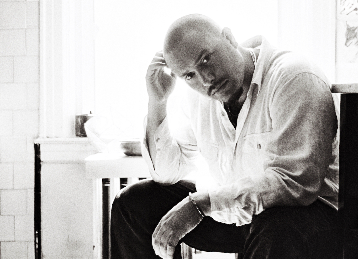 Nick Hakim sat in front of a window monochrome