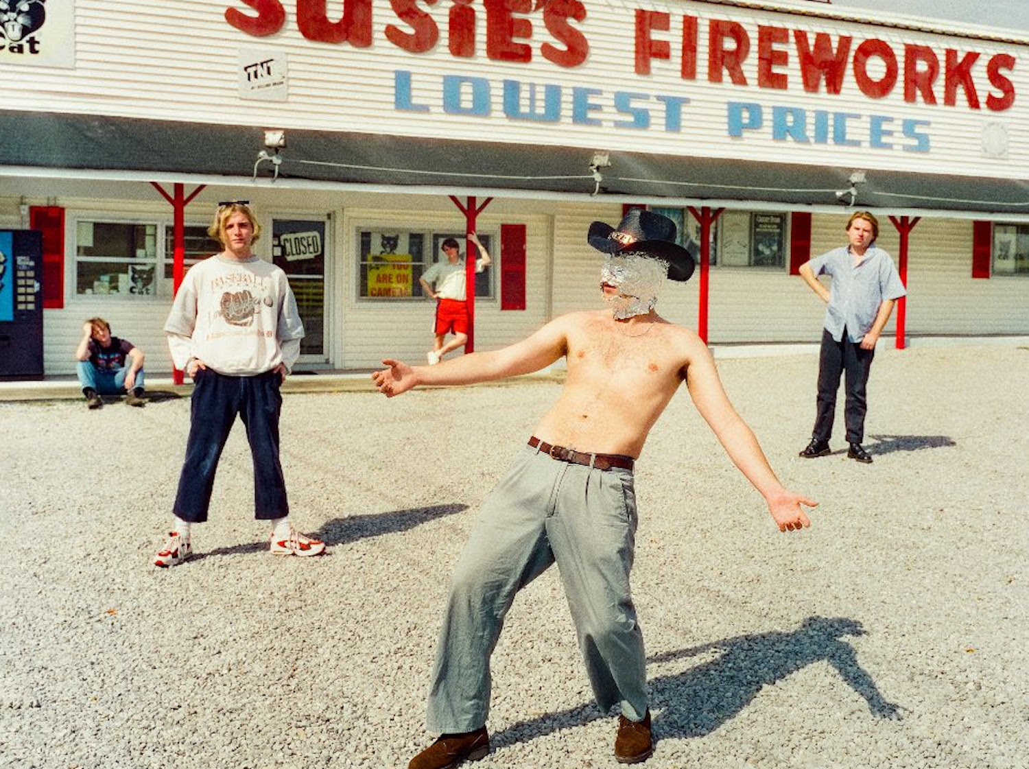 Shame outside fireworks shop lead singer cowboy hat foil mask