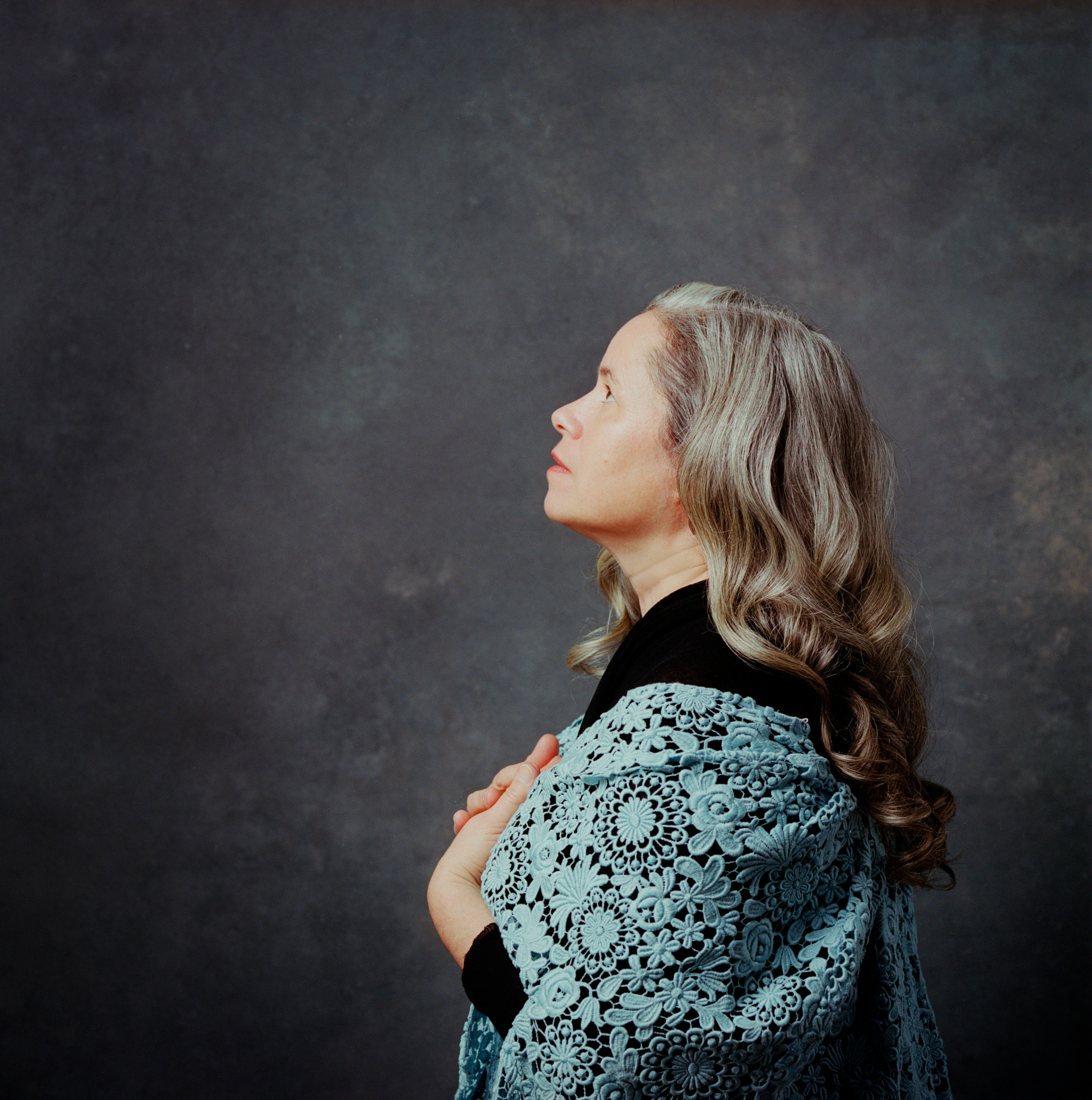 Side profile of Natalie Merchant wearing a shawl and looking up and to the left