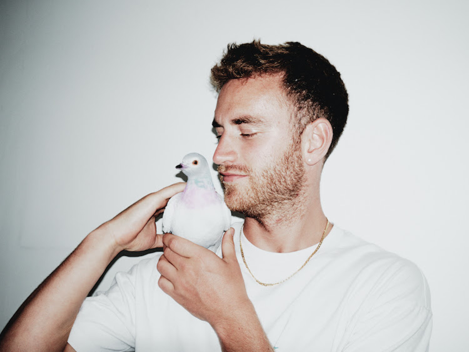 Supershy white t-shirt holding pigeon