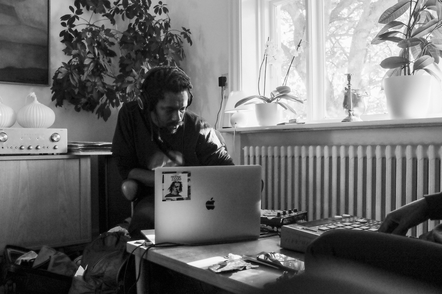 Teebs on laptop at table in monochrome