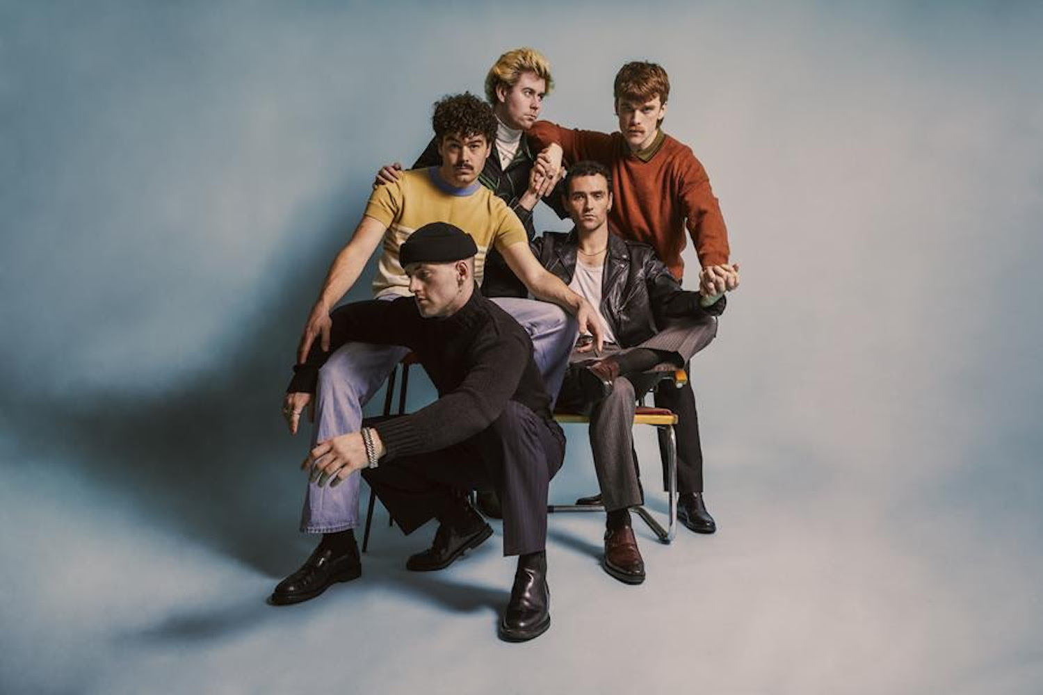 The Murder Capital blue backdrop sitting bandshot