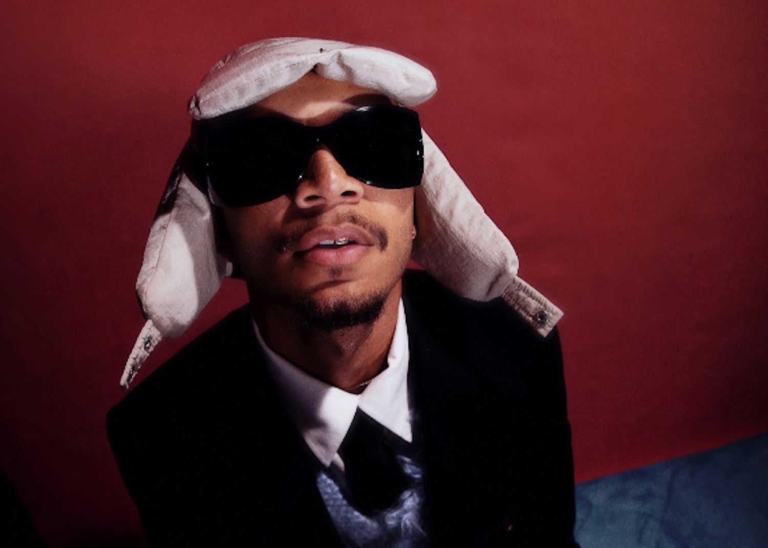 Wesley Joseph glasses hat red wall credit Wesley Joseph