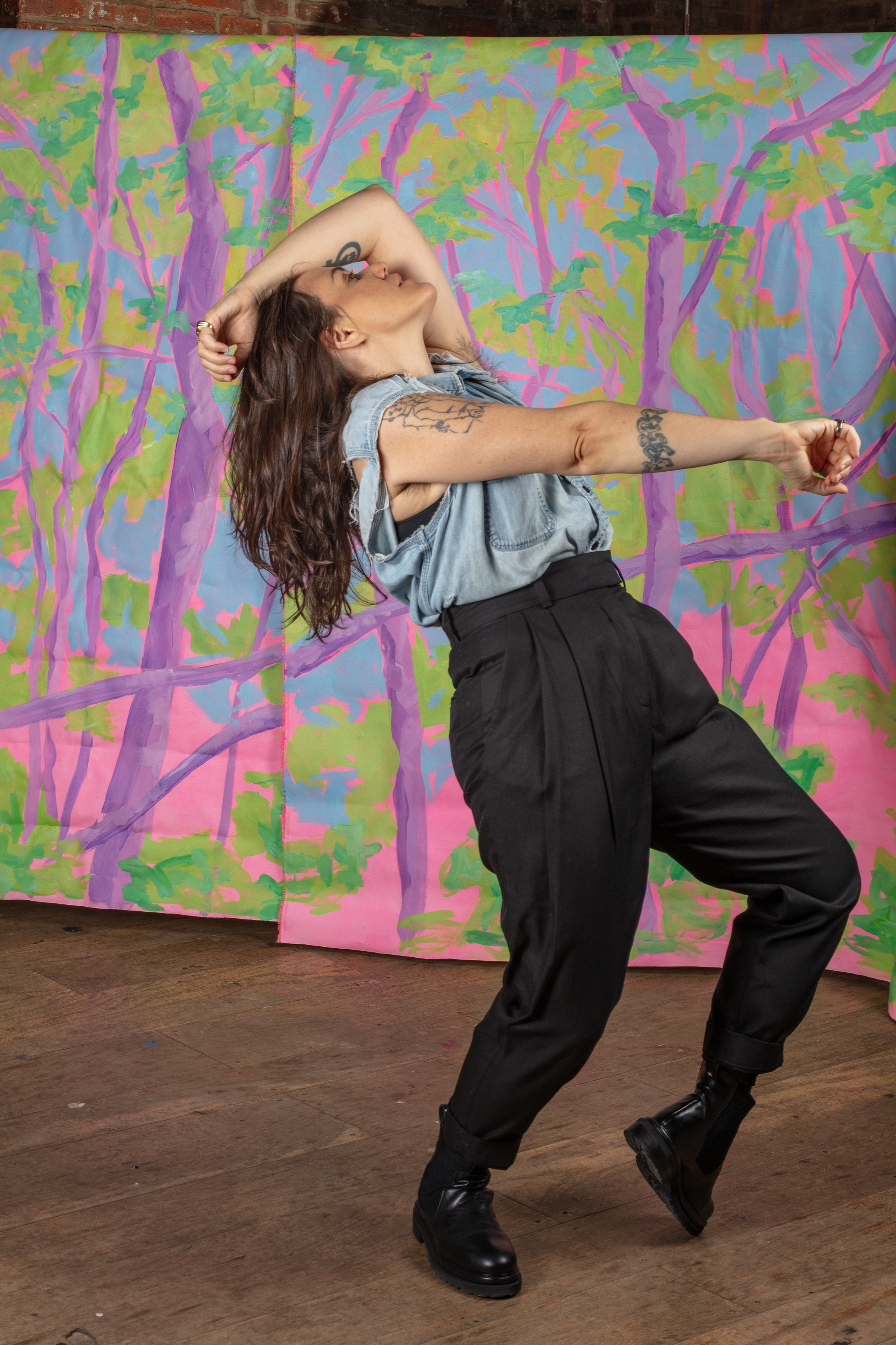 Emily Wells dancing, punching forward into the air and throwing her head back