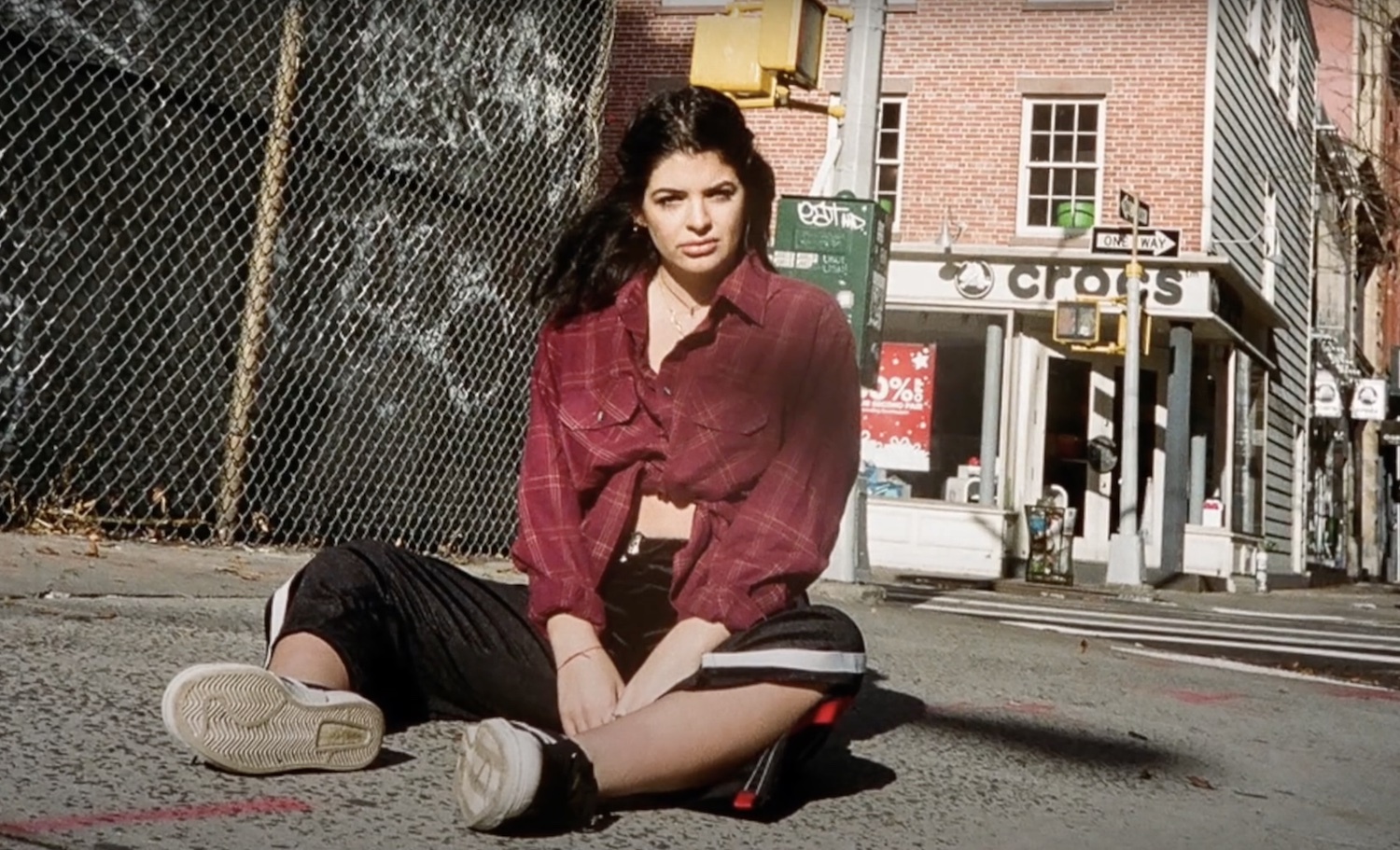 Indy Yelich sitting on pavement
