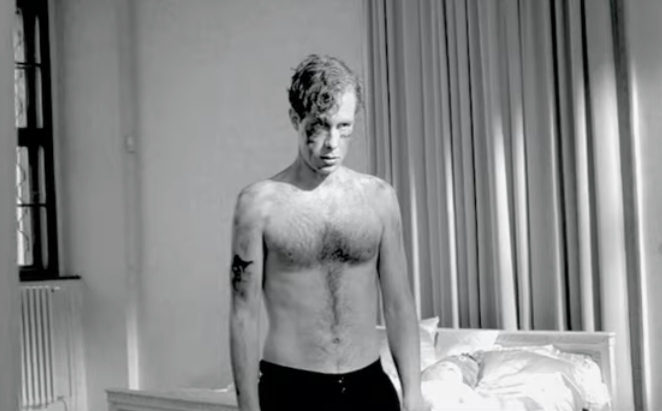 Shirtless man black and white room