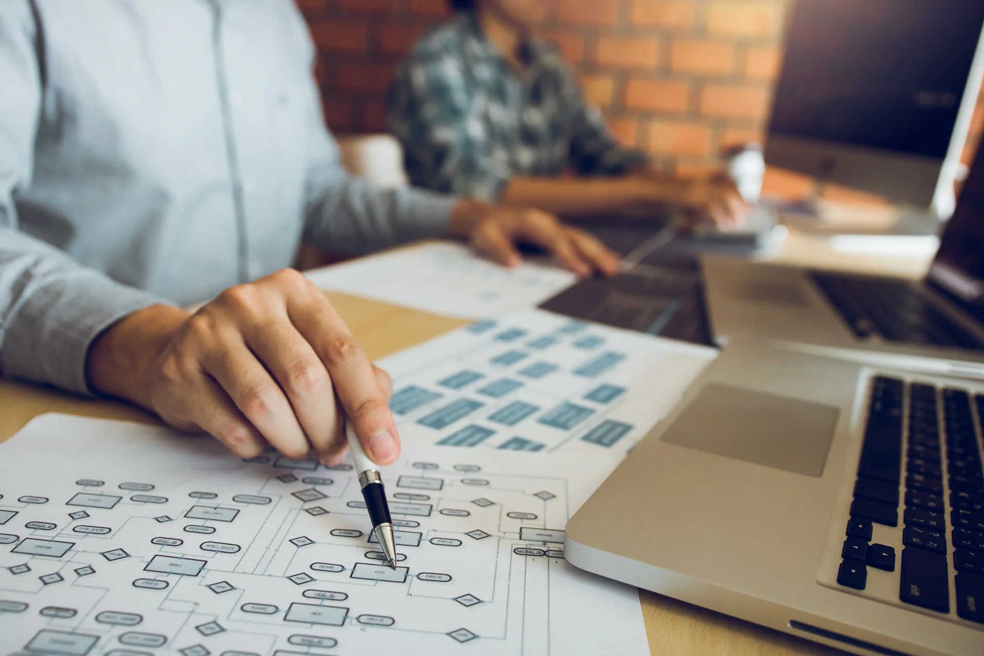 Software developer is pointing to the paper workin 2024 12 02 04 07 06 utc