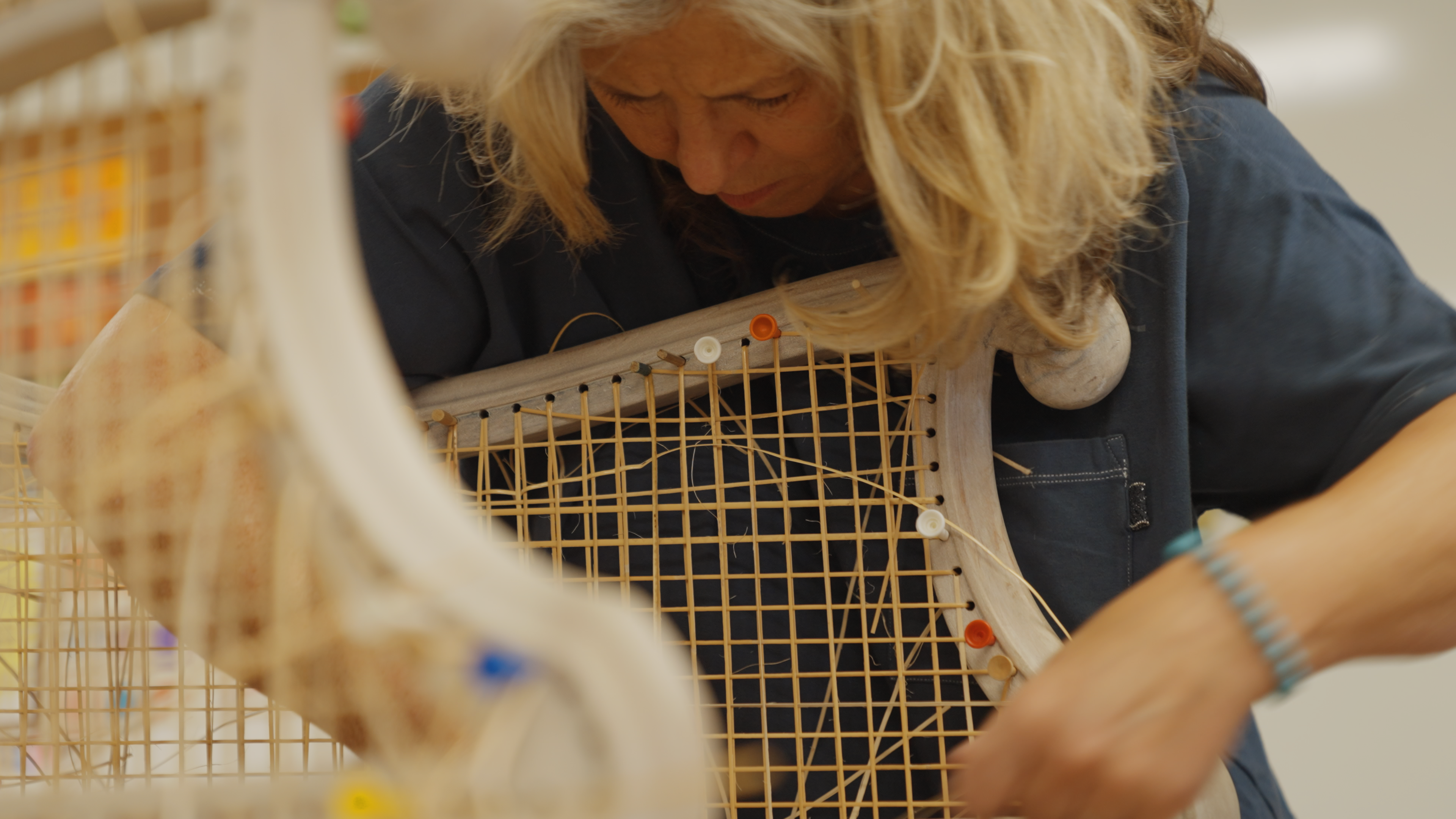 Woman upholstering a chair.