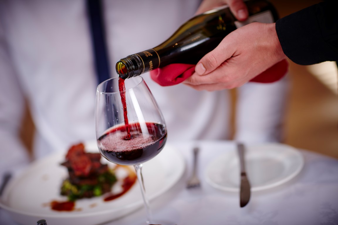 Culinary Arts - Pouring a Glass of Red Wine at a Restaurant