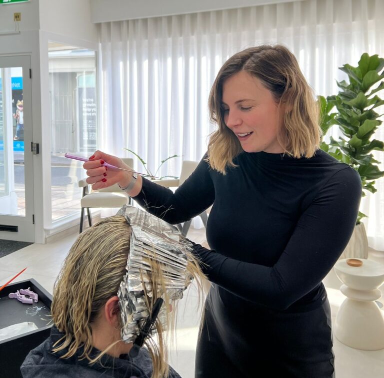 Hair and Beauty - Hairstylist Applying Foil Highlights to Client's Hair