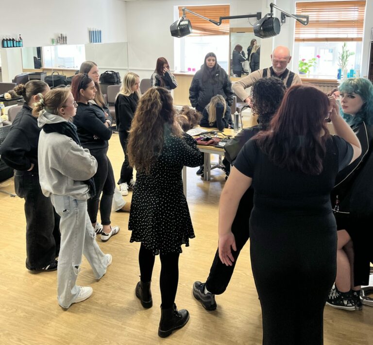 Hair and Beauty - Students Gathered Around Instructor in a Salon Classroom