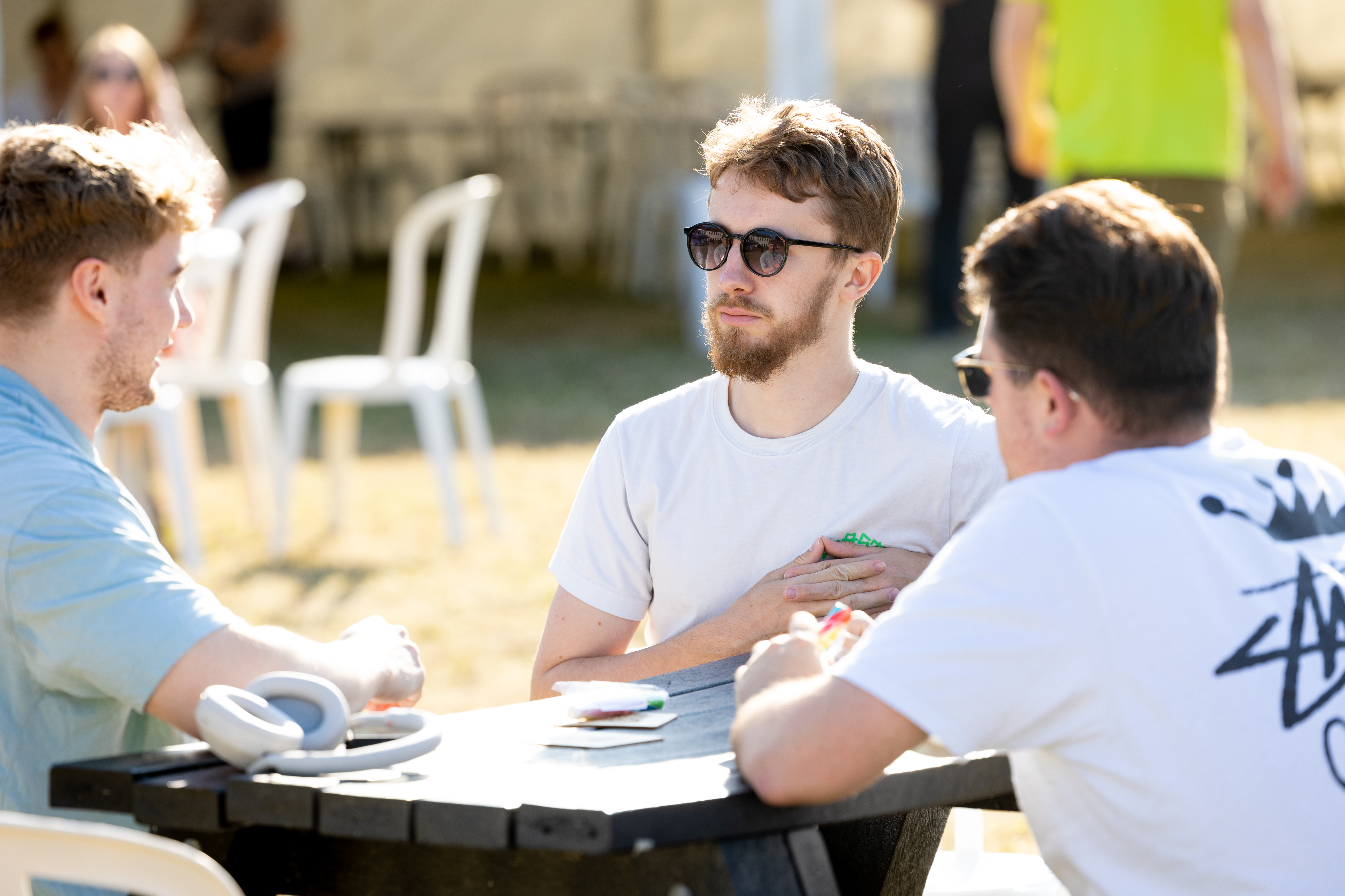 A Group of 3 Alumni during a Discussion at a Highlands Connected event on a sunny day!