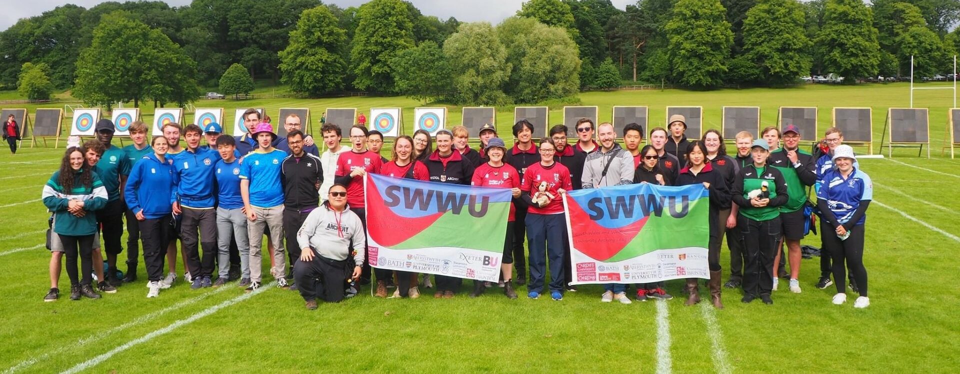 Group of people after competition posing for a shot with flags
