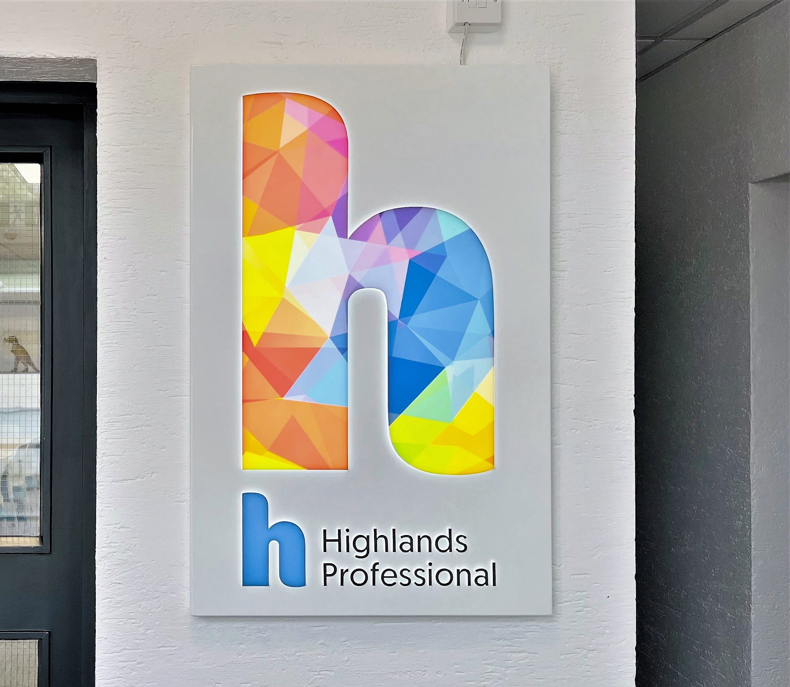 Highlands Professional Logo displayed inside the Professional Studies Centre building.