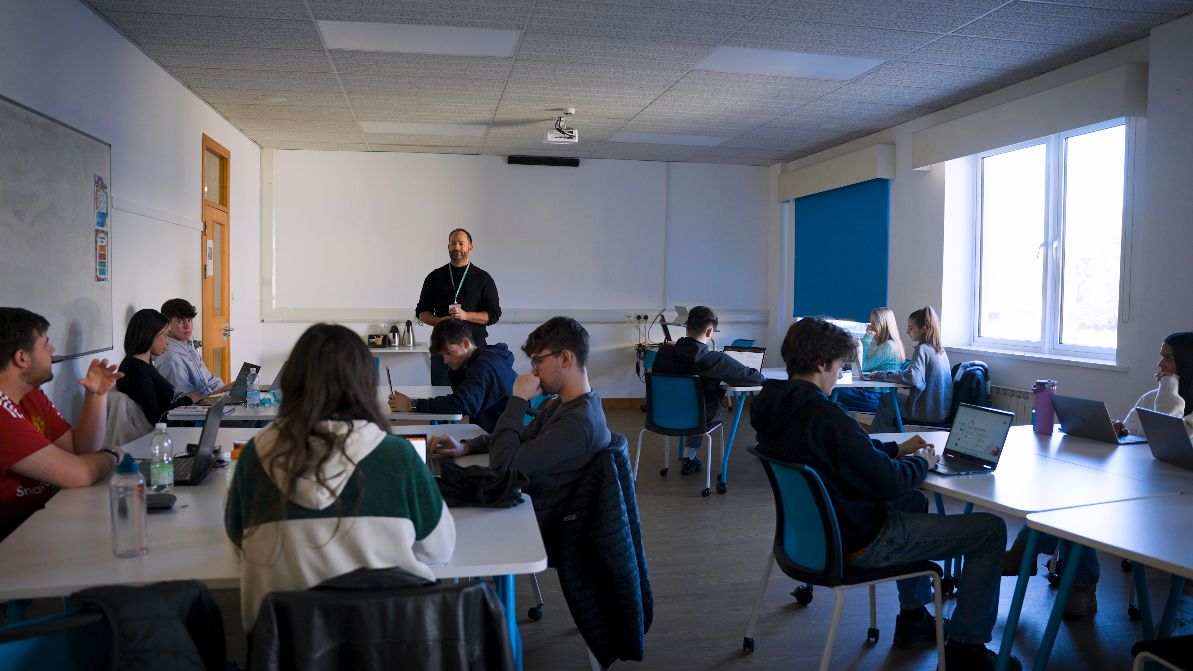 A medium wide shot of a classroom filled with students.