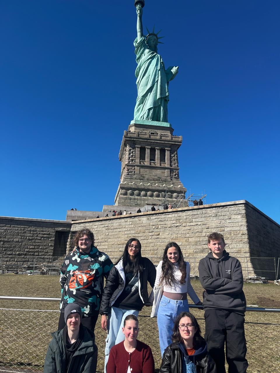 UCJ students in New York standing in front of the Statue of Liberty.
