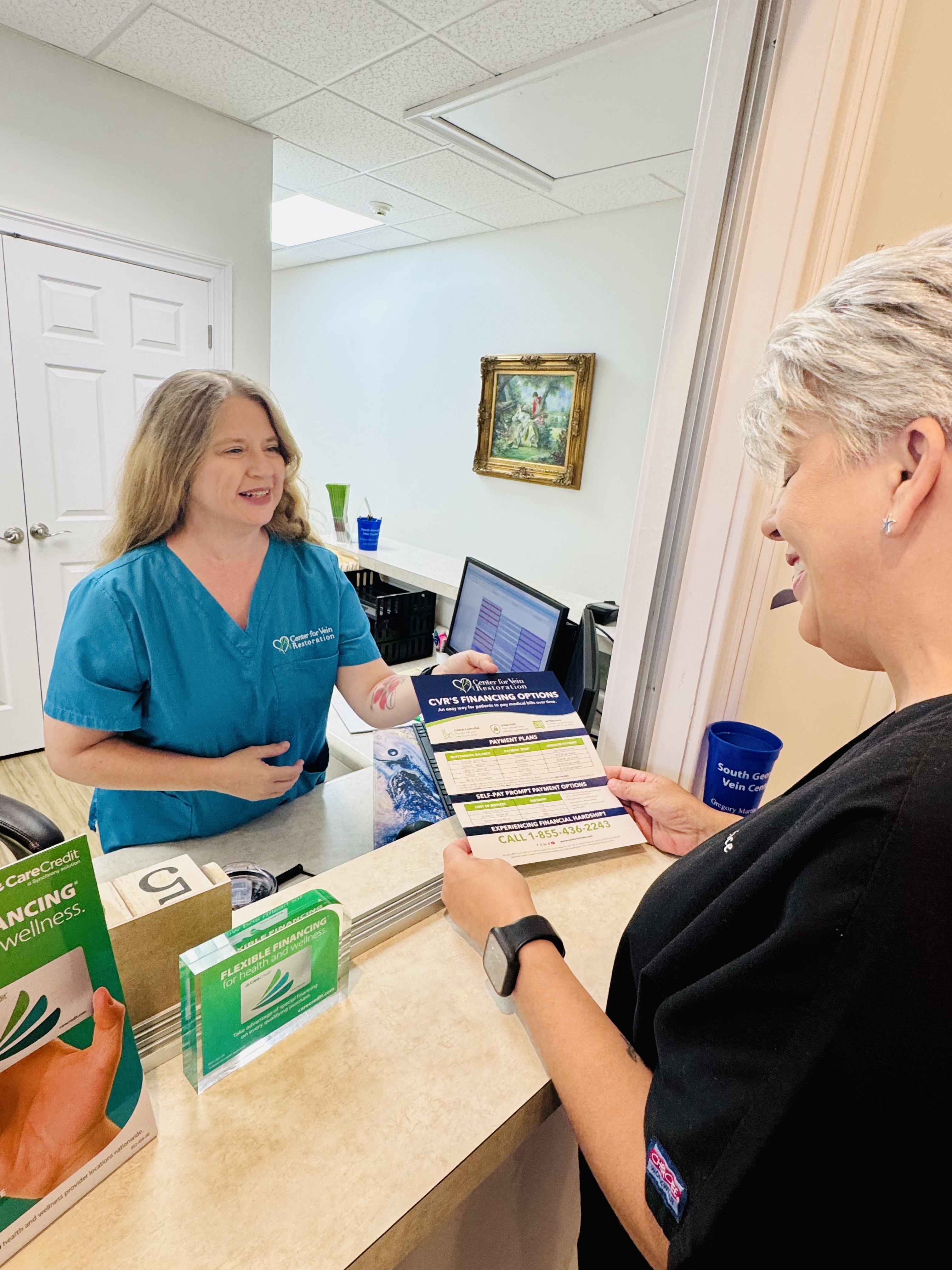 Interior photo of the Valdosta, GA Center for Vein Restoration showing the front desk working with a patient