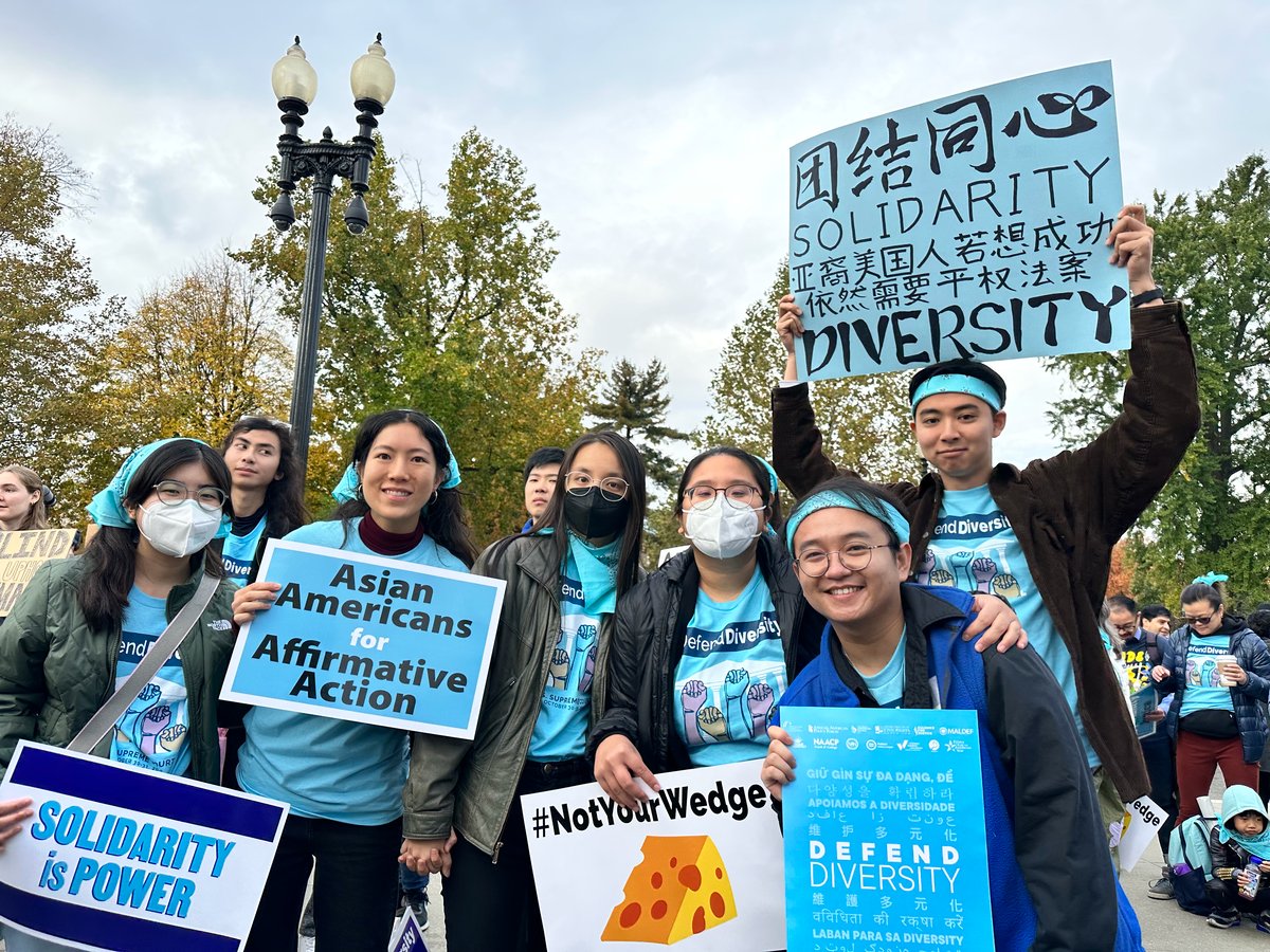 Students rally outside the Supreme Court in 2022, calling for race-conscious admissions and holding signs that say "Solidarity is Power" and "Not Your Wedge."