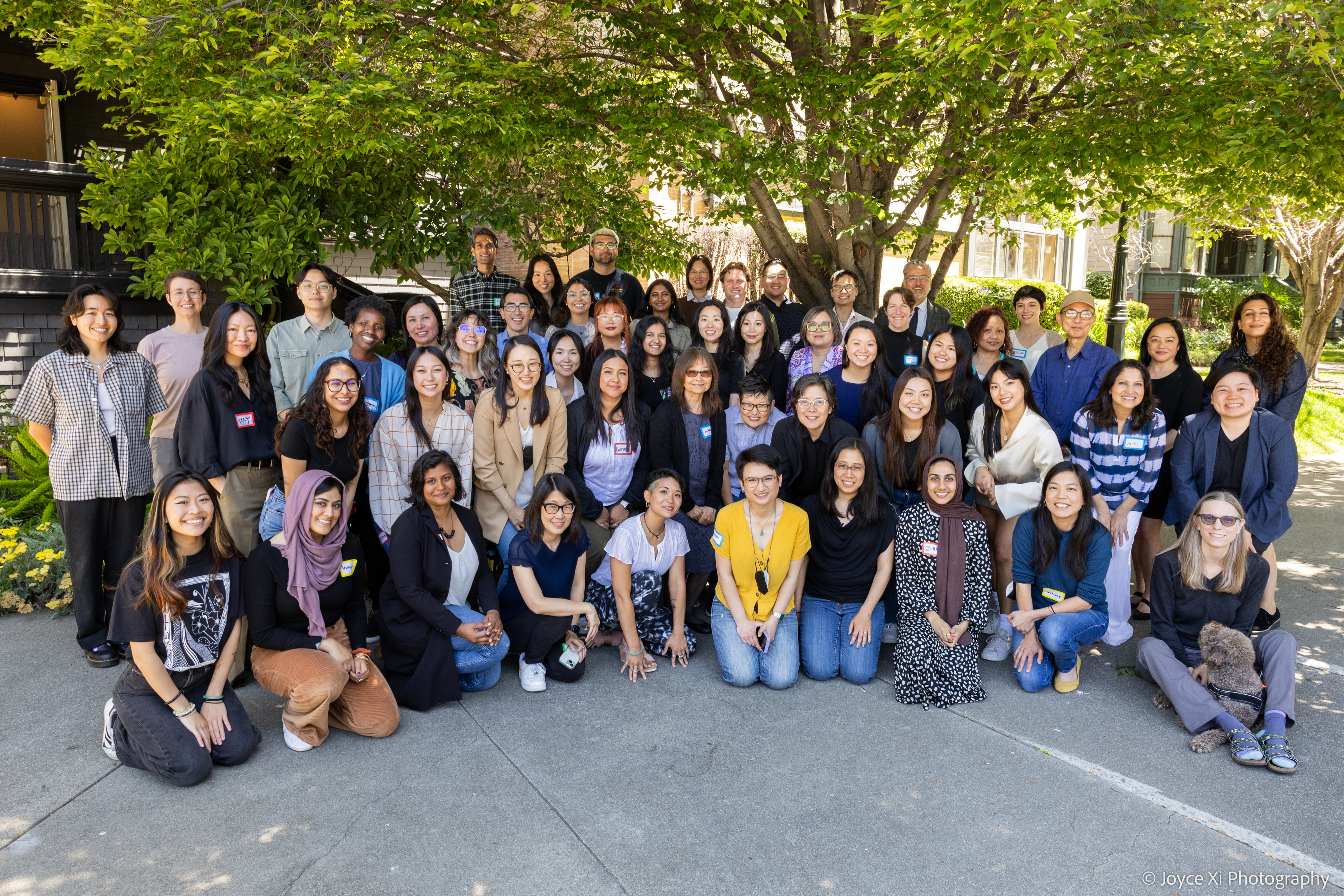 Asian Law Caucus staff gather under a tree at our June 2024 retreat in Oakland.