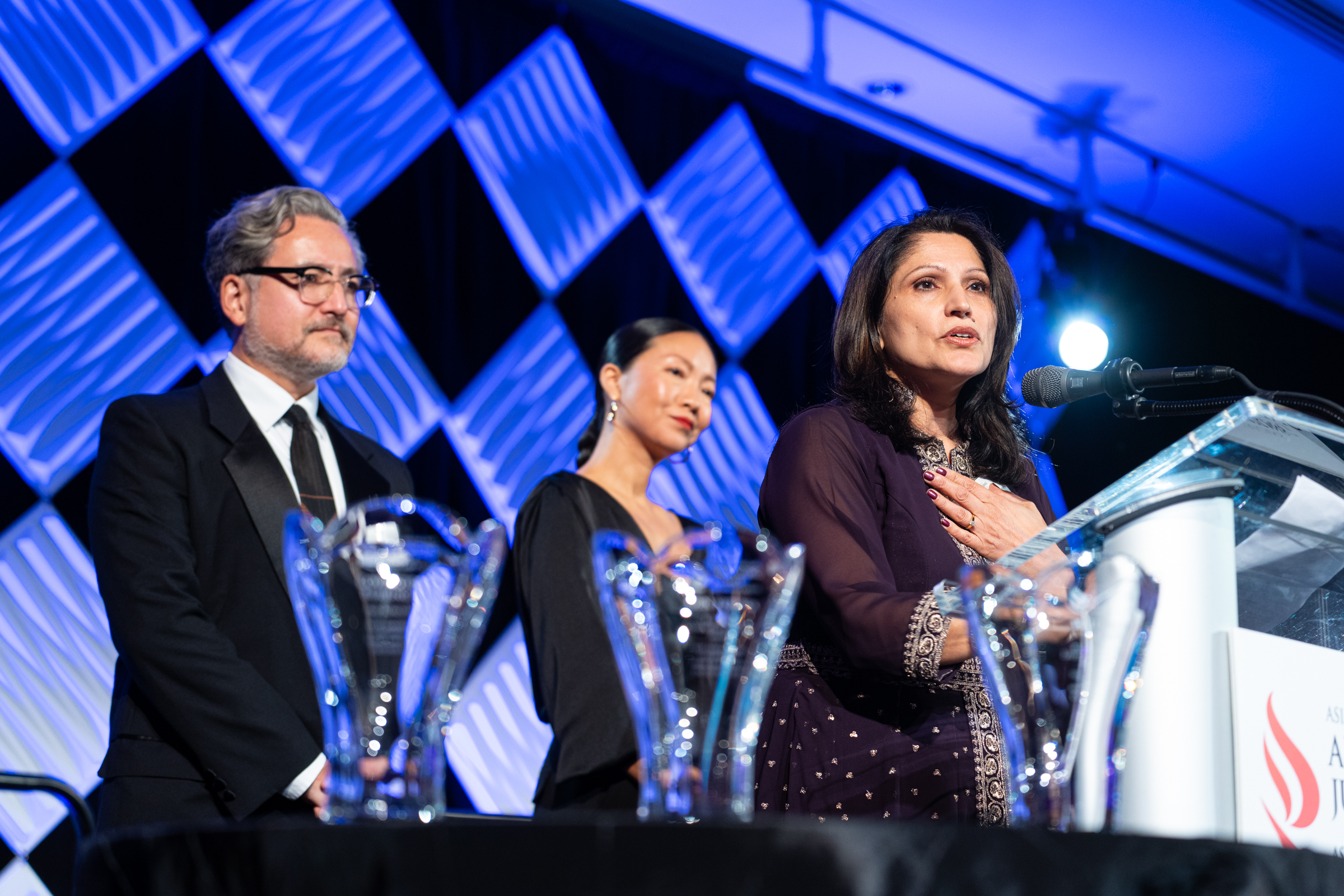 ALC's executive team members stand on the stage at the organization's 51st anniversary gala.