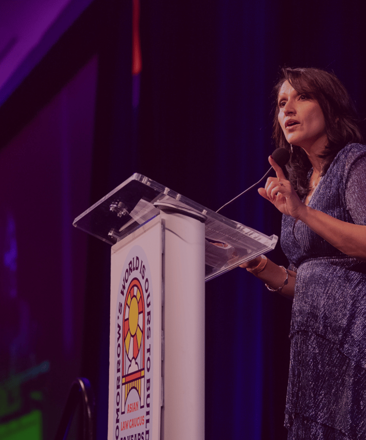 ALC Executive Director Aarti Kohli addresses the audience of supporters at a podium at the 50th Anniversary Gala.
