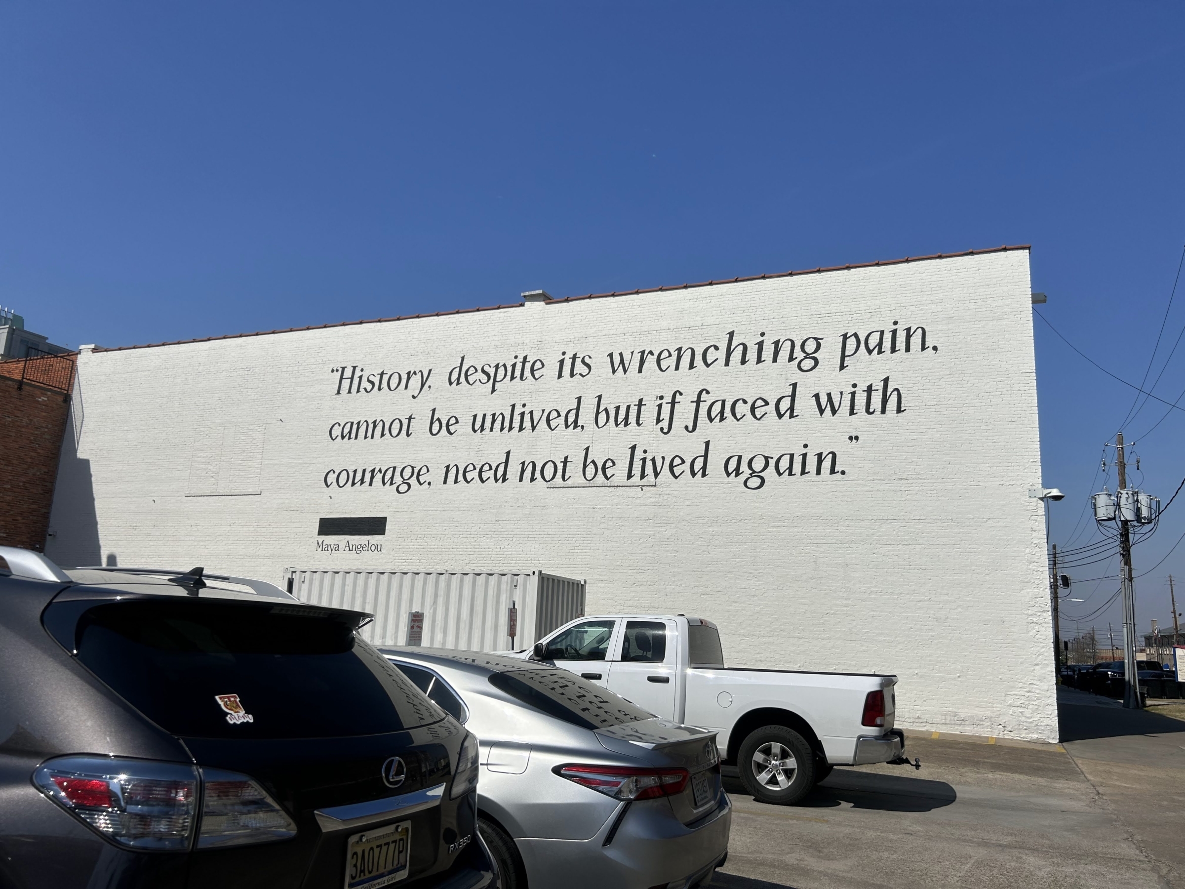 A quote by Maya Angelo on a large white building reads, "history, despite its wrenching pain, cannot be unlived, but if faced with courage, need not be lived again"