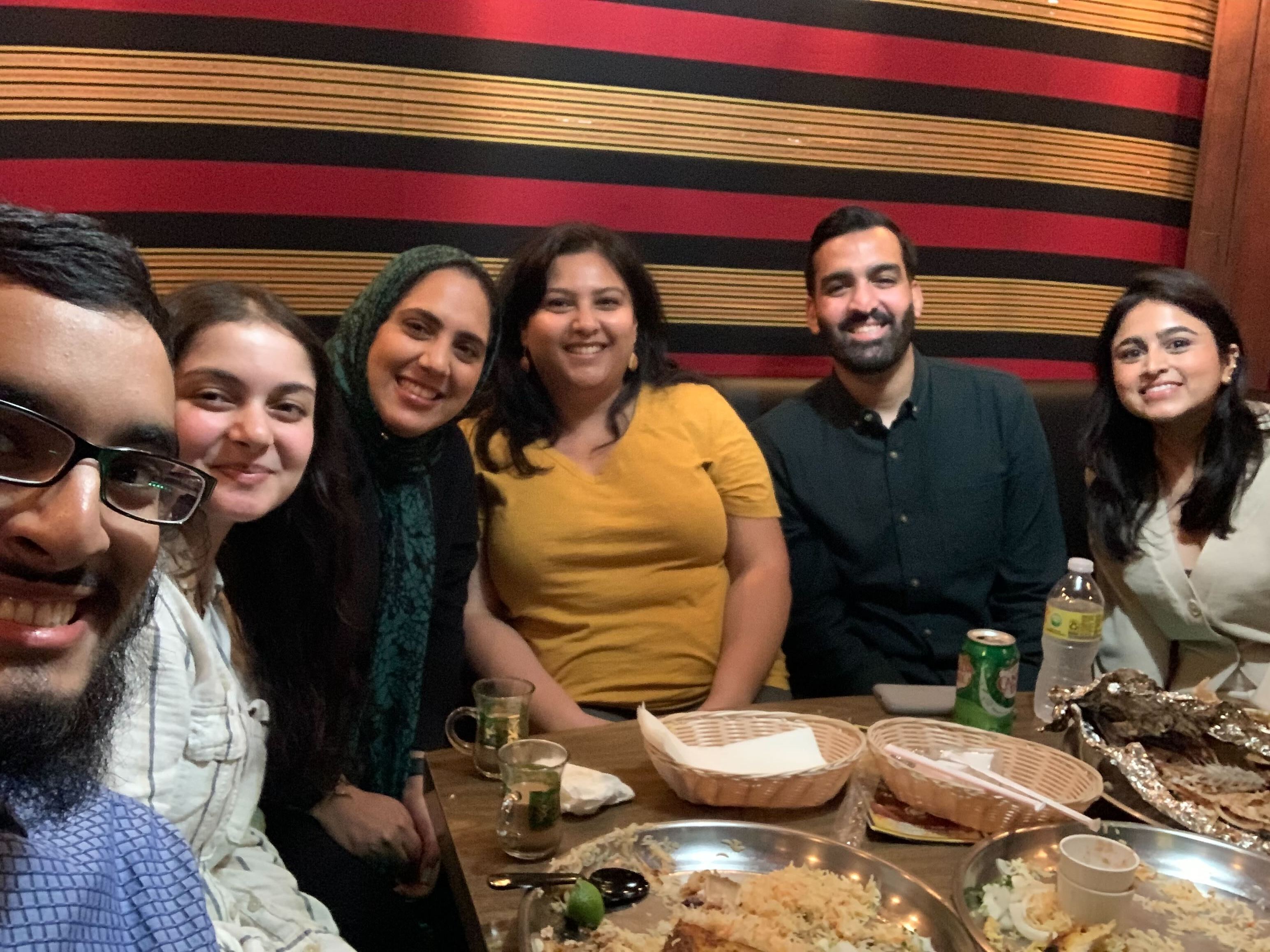 Hammad Alam and ALC staff members and partners gather for a meal.