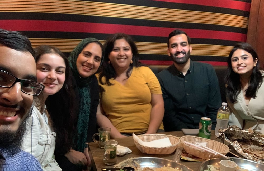 Hammad Alam and ALC staff members and partners gather for a meal.