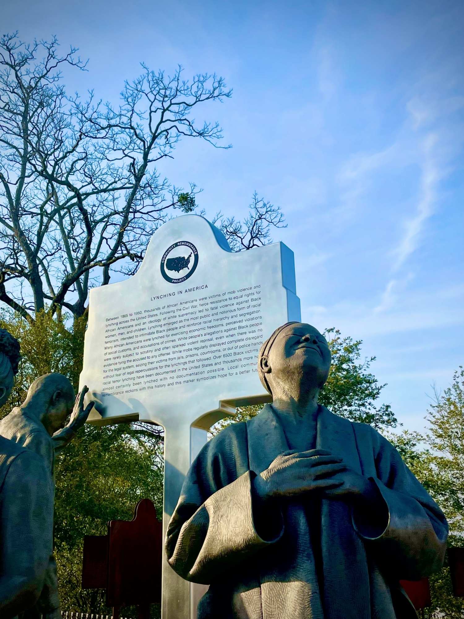 A statue of a women with her hands crossed on her chest, representing an activist from the Equal Justice Initiative.