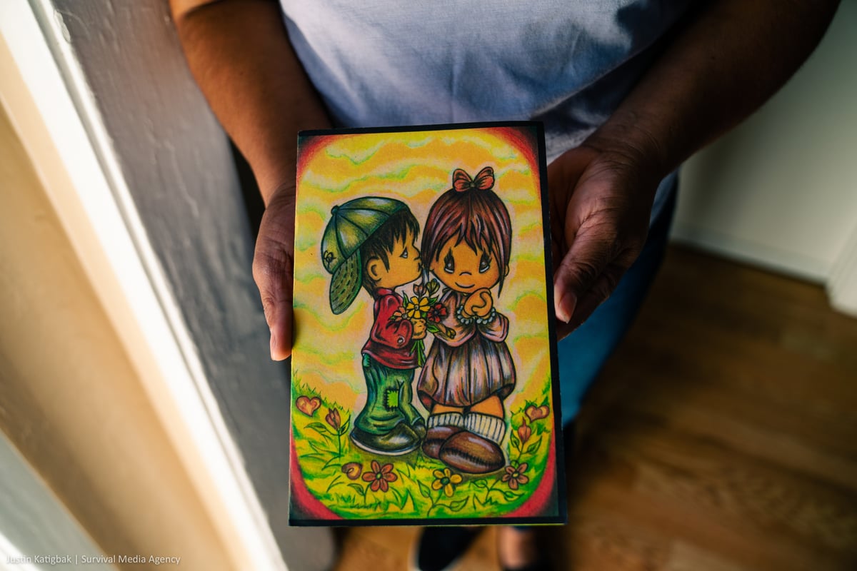 A drawing of 2 kids hugging, illustrated by Angel.