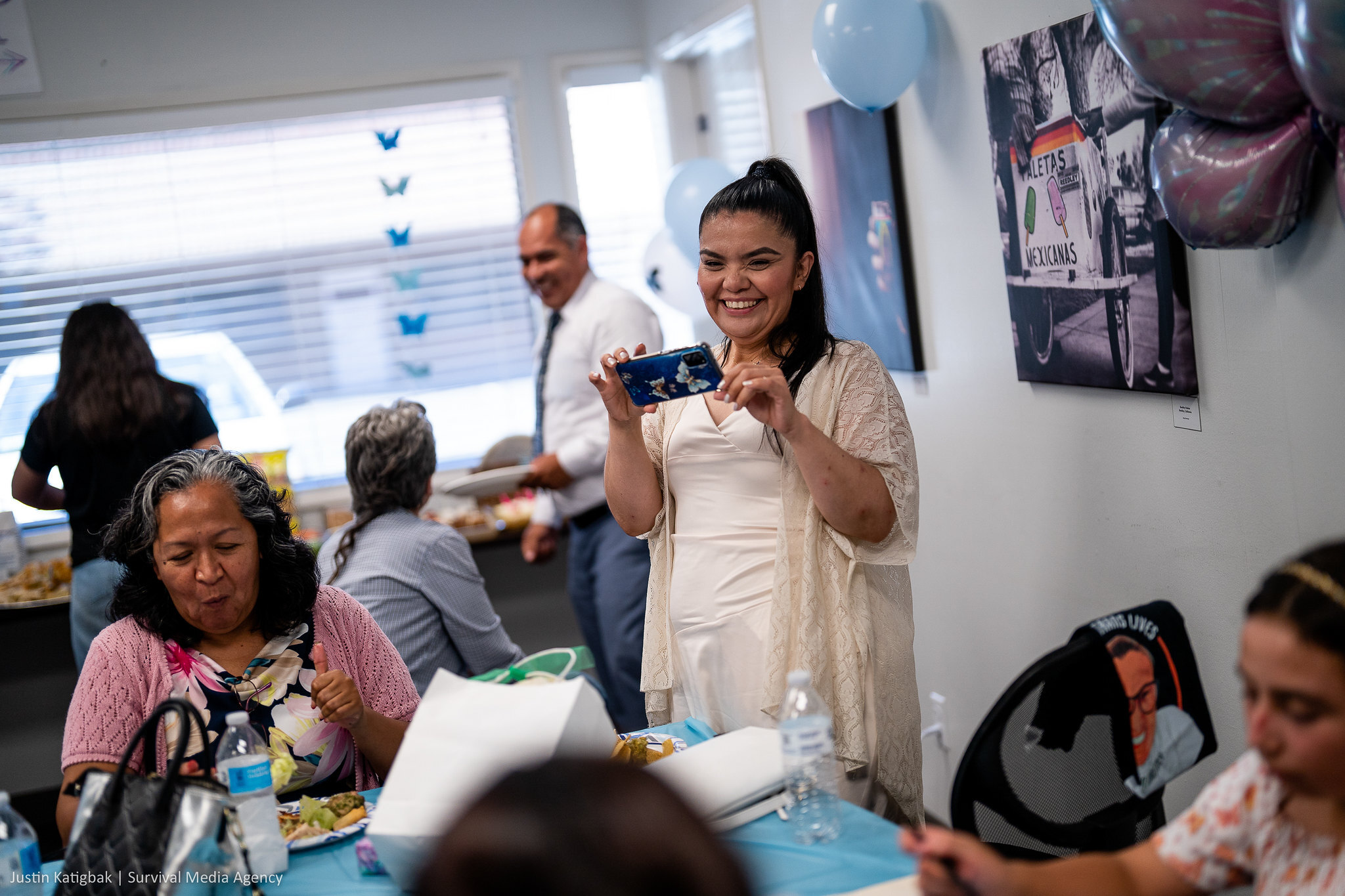 Marisela Andrade takes photos of friends, family, and supporters at her birthday celebration (Justin Katigbak | Survival Media Agency)