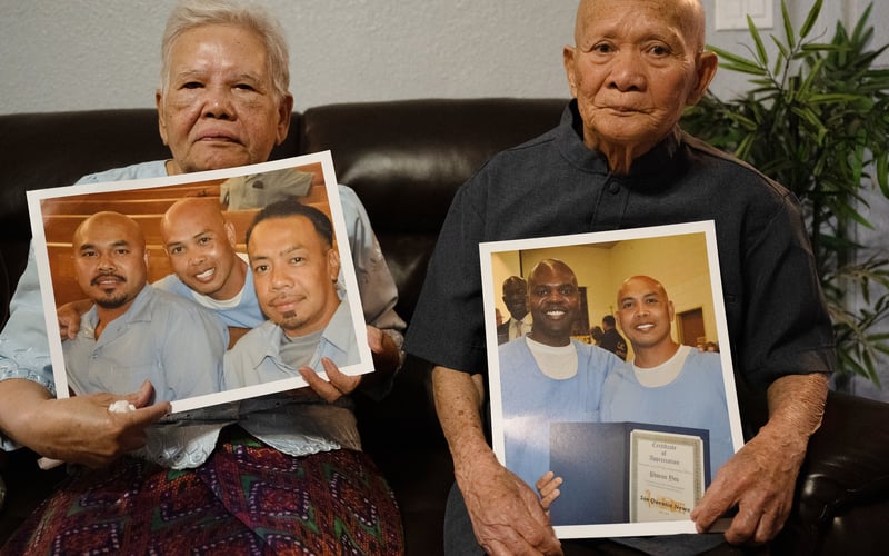 Phoeun You’s mother Yai ma Mony, and father Ket You hold photos of him.