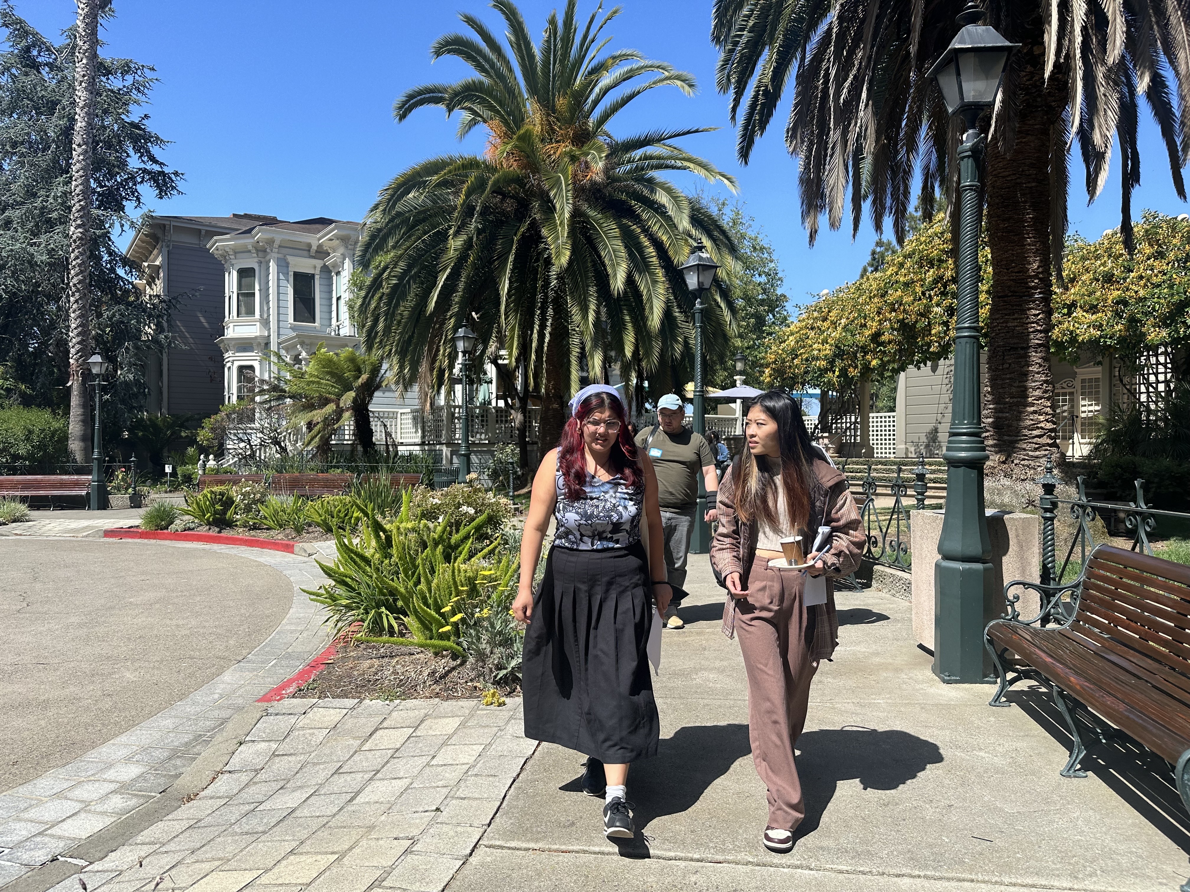 Housing rights community advocates Amalia and Faustina walking on the sidewalk.