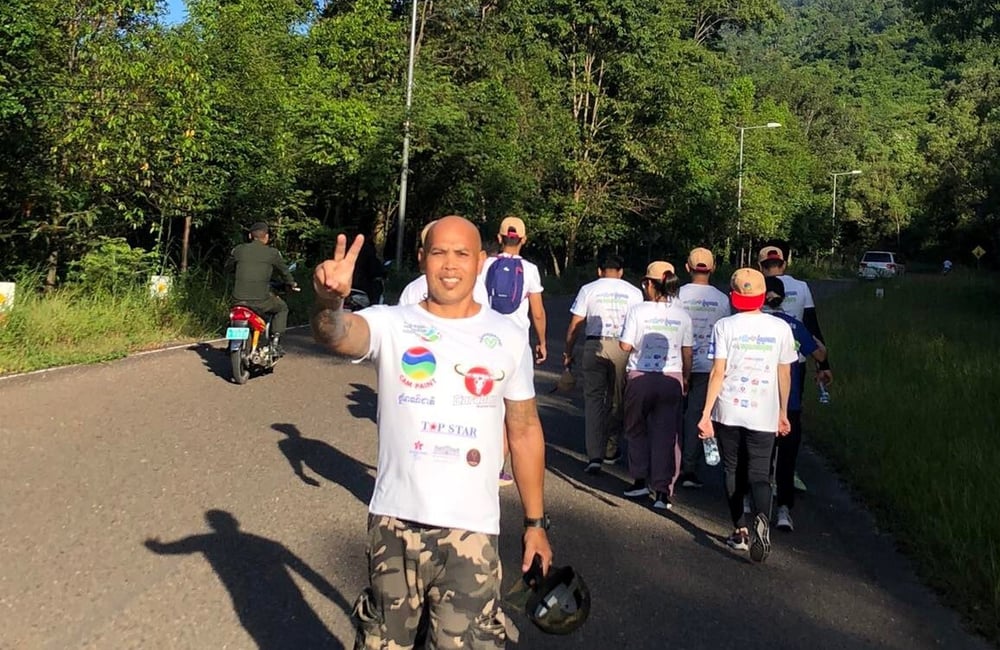 Phoeun poses with a peace sign after participating in a cancer walk.