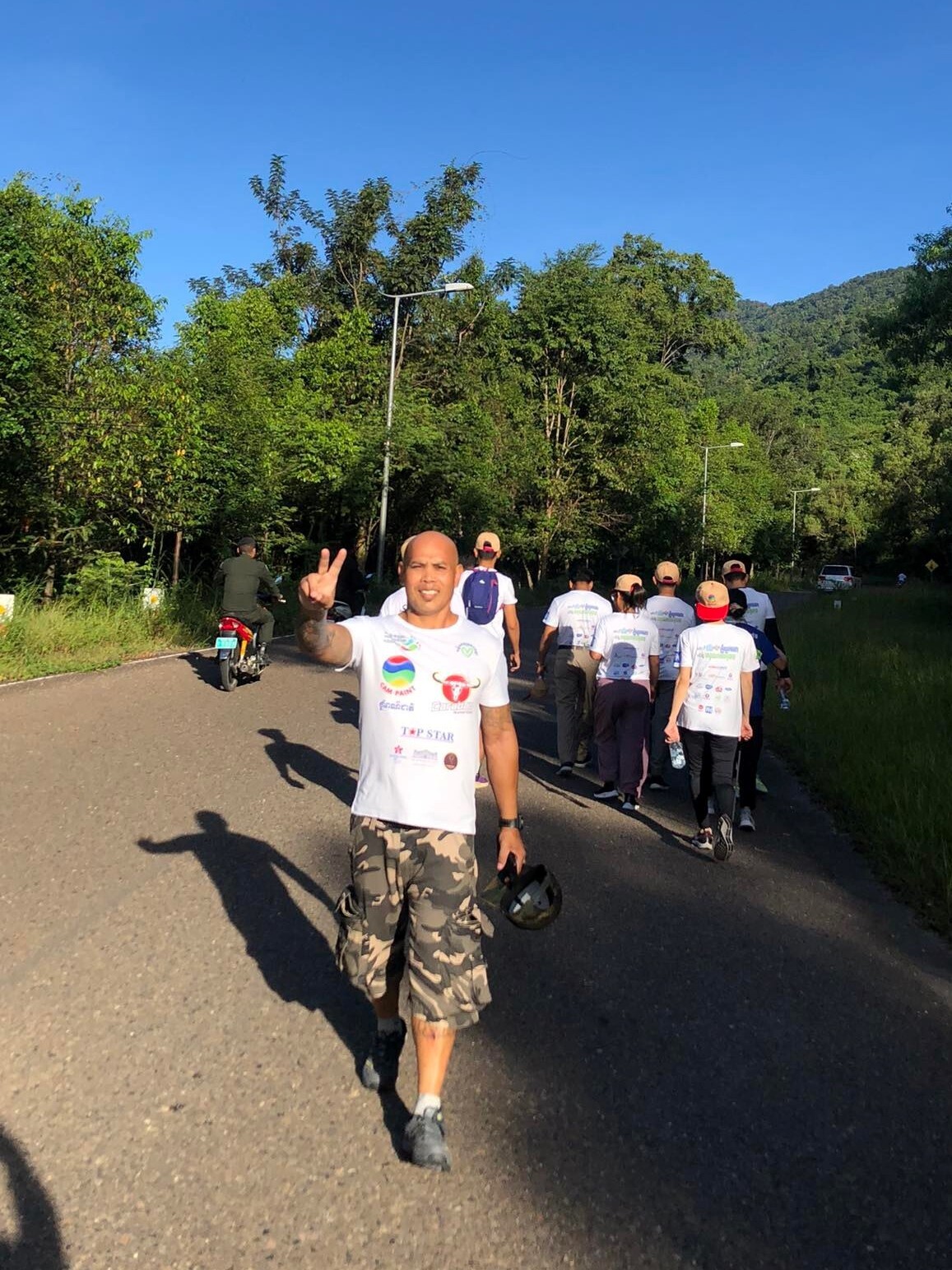 Phoeun poses with a peace sign after participating in a cancer walk.