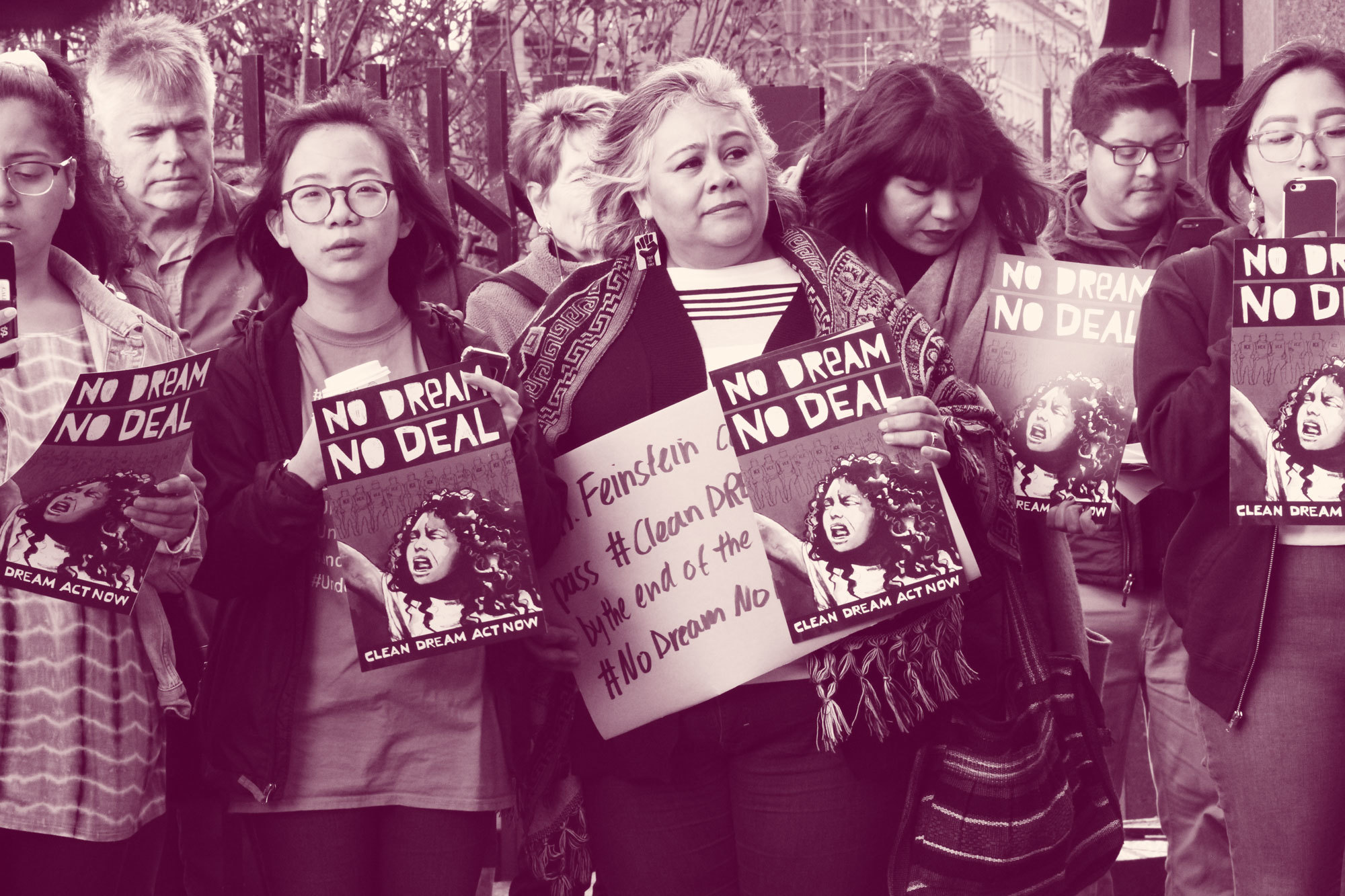 Group of seven people hold signs reading "no dream no deal"