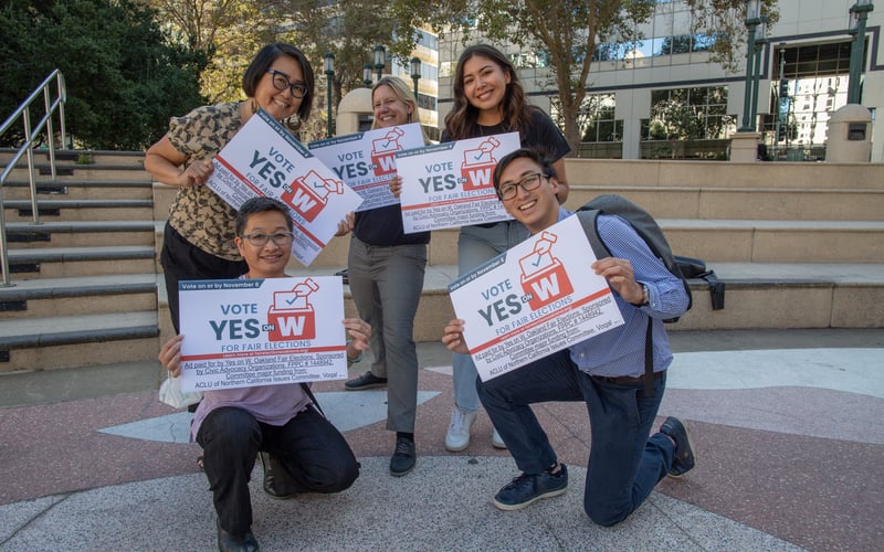 ALC Voting Rights Staff and community partners pose in a group photo holding signs that read "Yes on Measure W"