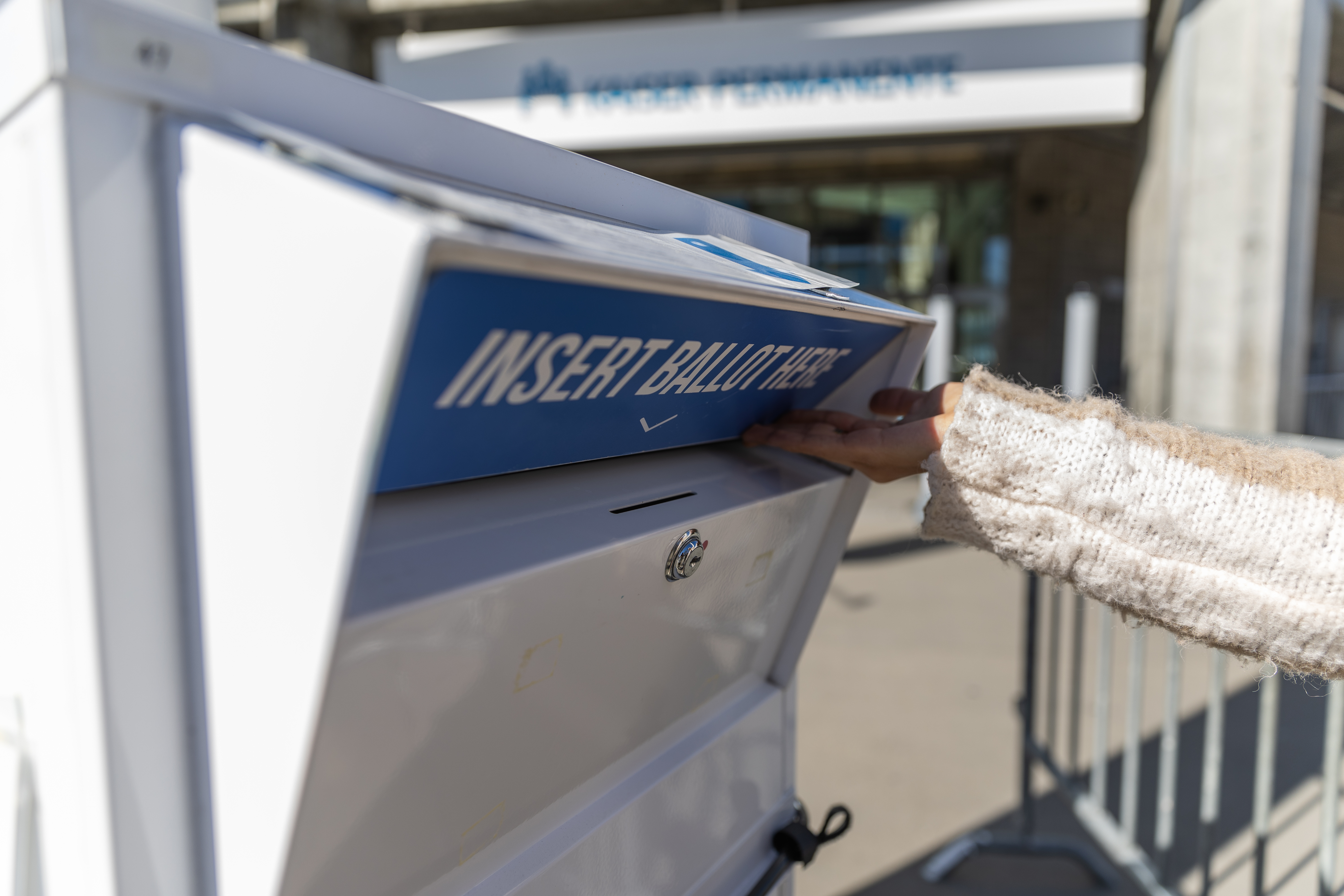 A ballot box with the text 'Insert Ballot Here' being opened.